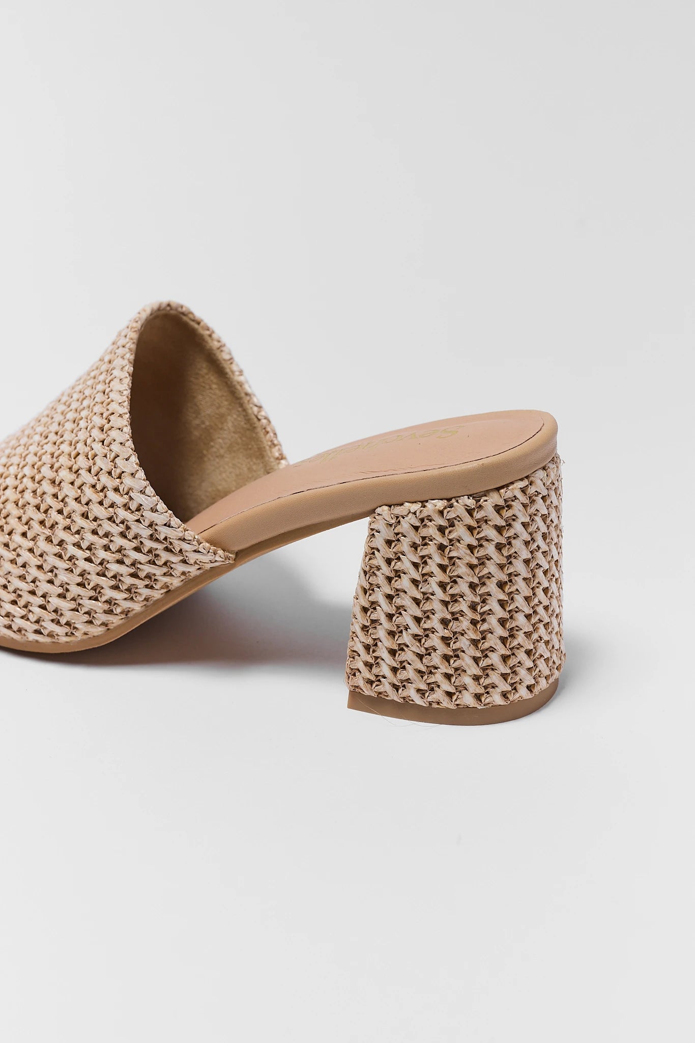 Beige woven sandal with a block heel on a light gray background details