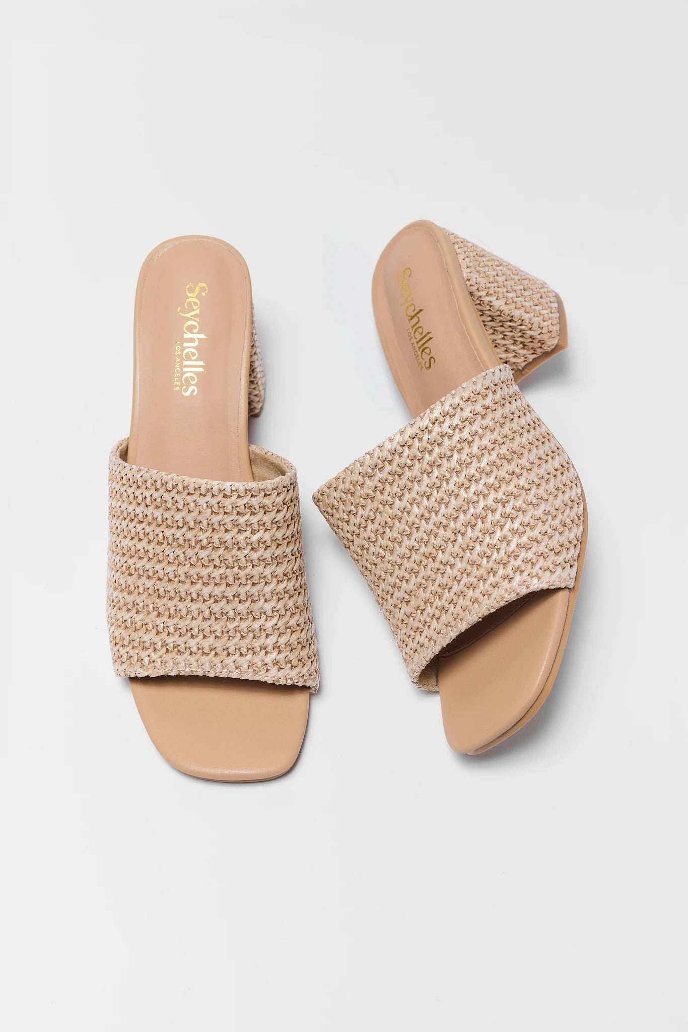Pair of woven heels with open toes on a light gray background