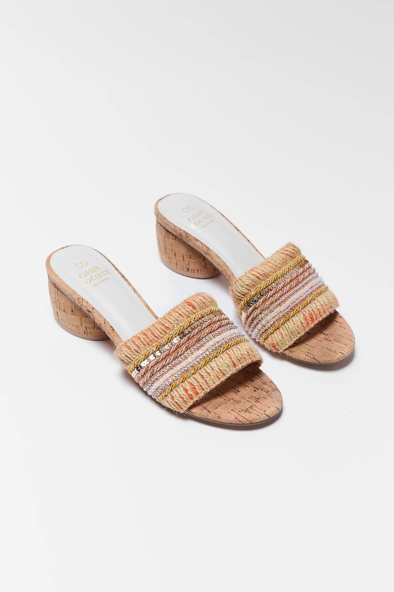 Pair of cork sandals with colorful straps on a white grey background