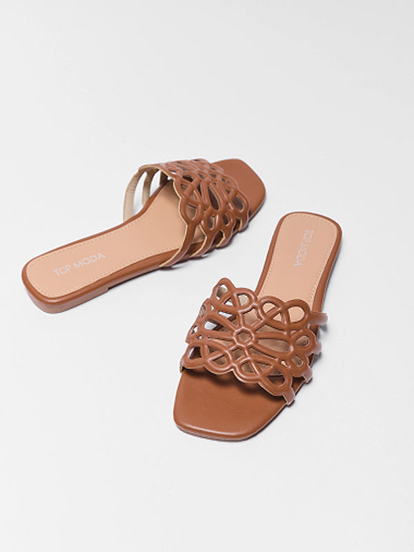 Pair of brown sandals with intricate design on a light gray background nav