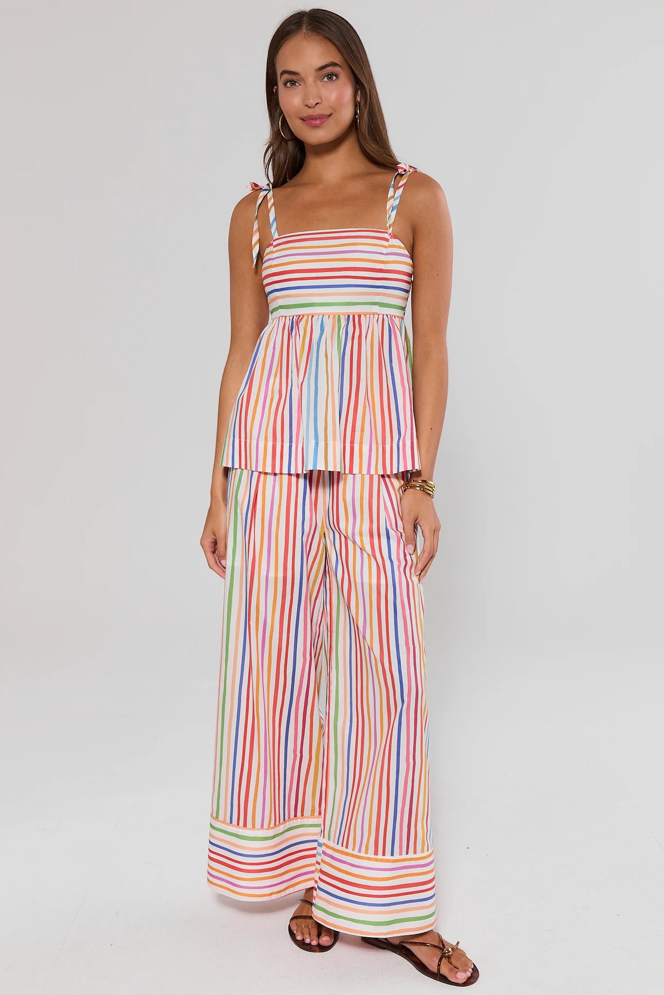 Woman wearing a colorful ava striped top and pants on a white background