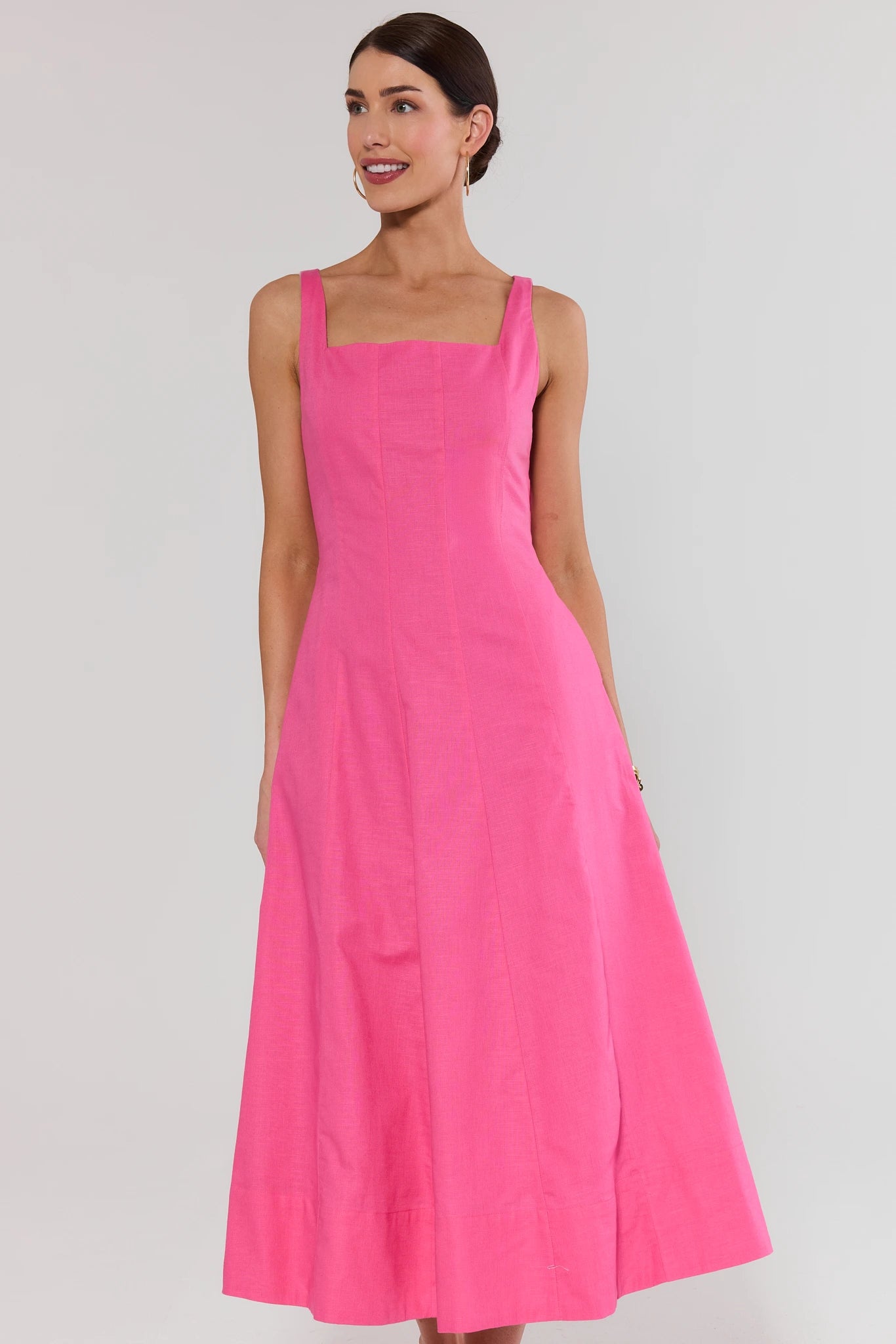 Woman wearing a pink dress against a white background