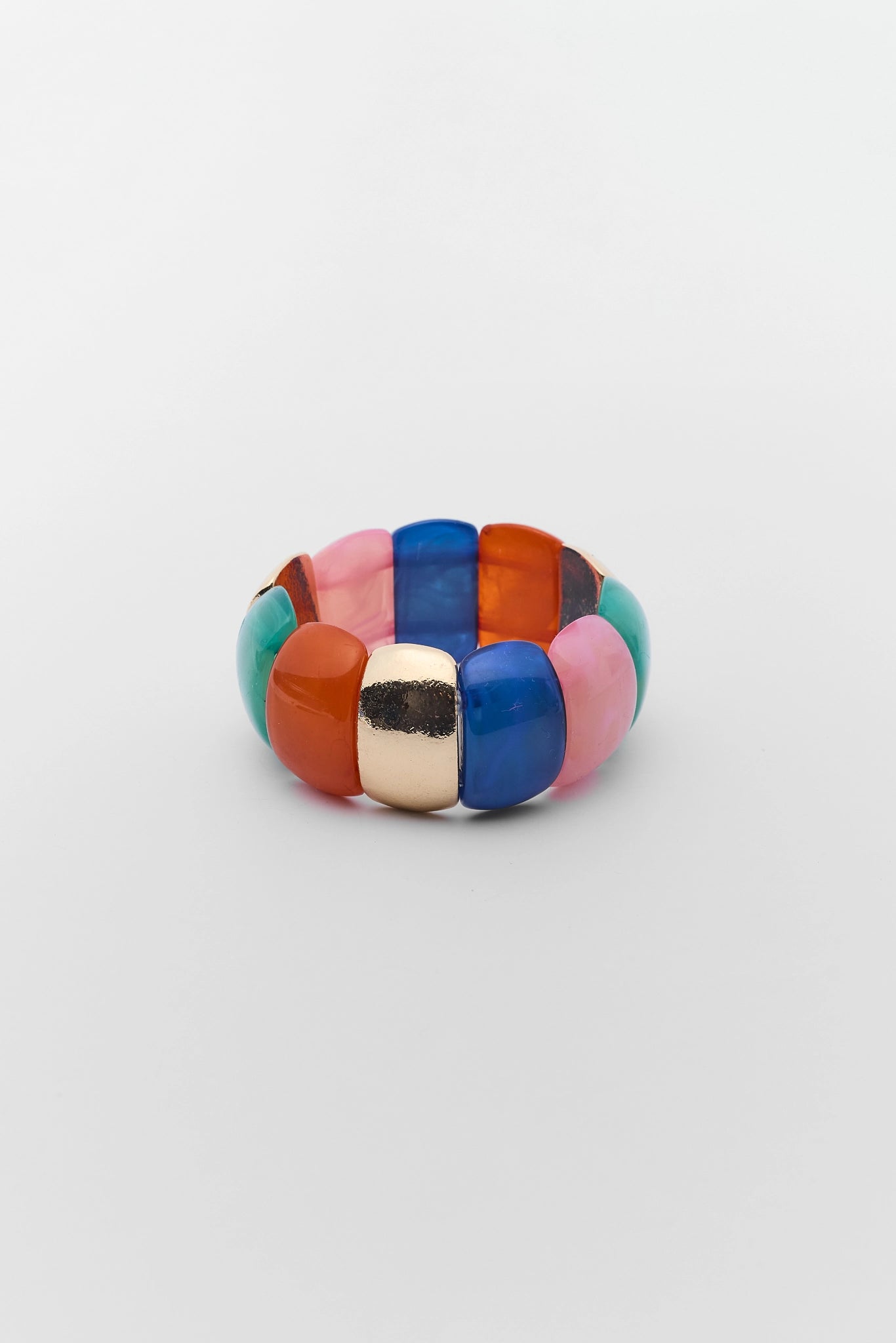 Multicolored ring with geometric design on a light gray background