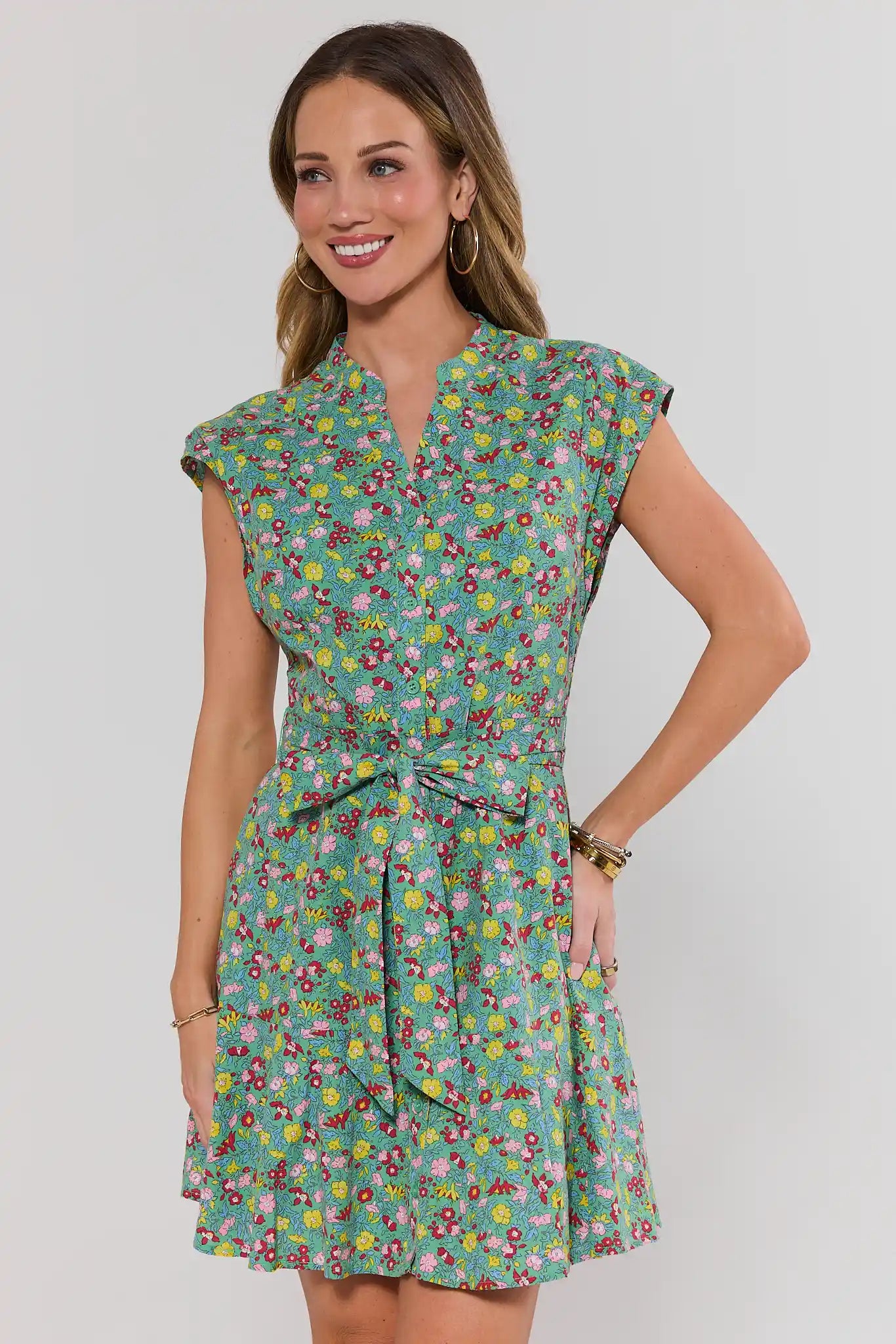 Woman wearing a floral dress against a plain background
