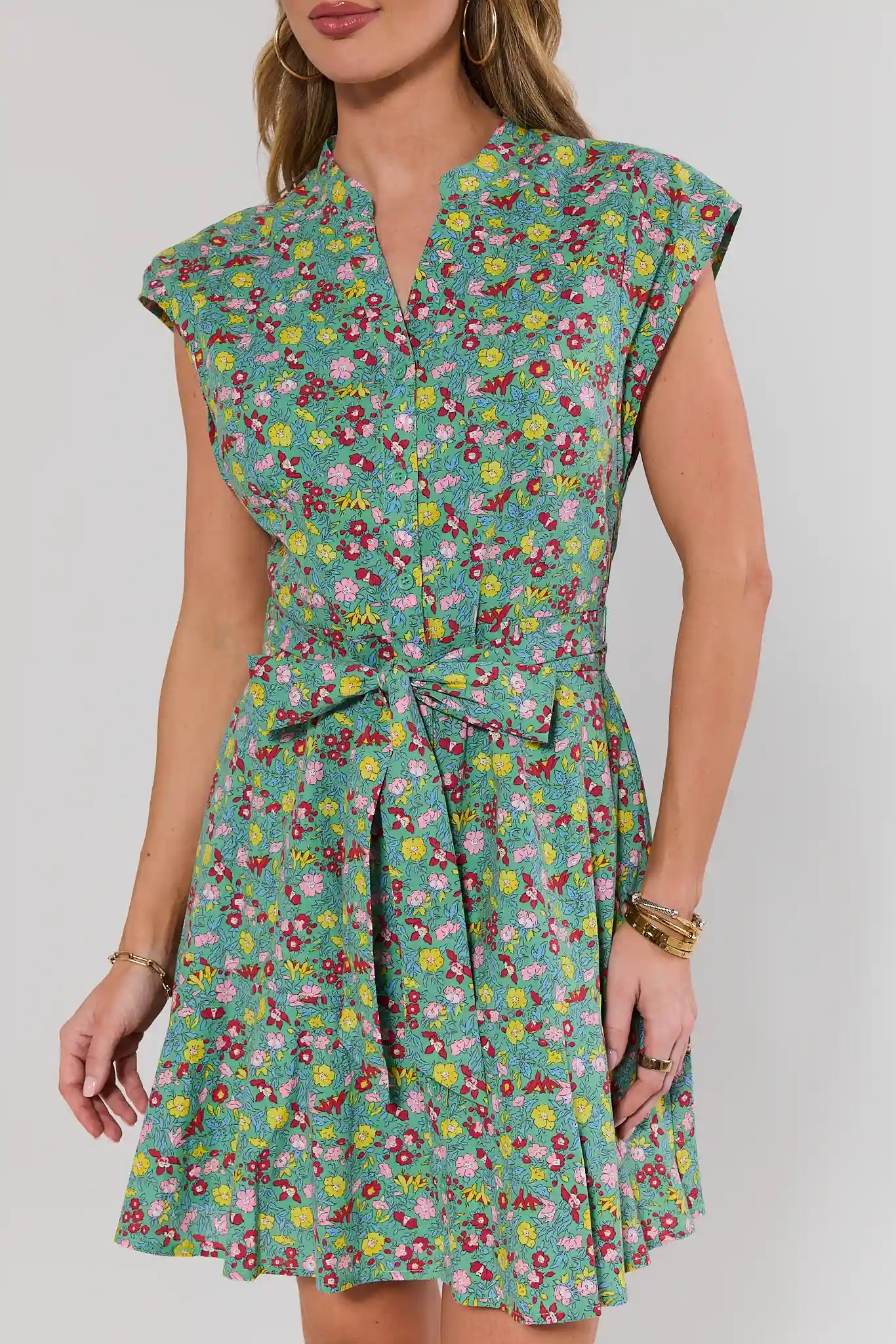 Woman wearing a floral dress with a plain background close up