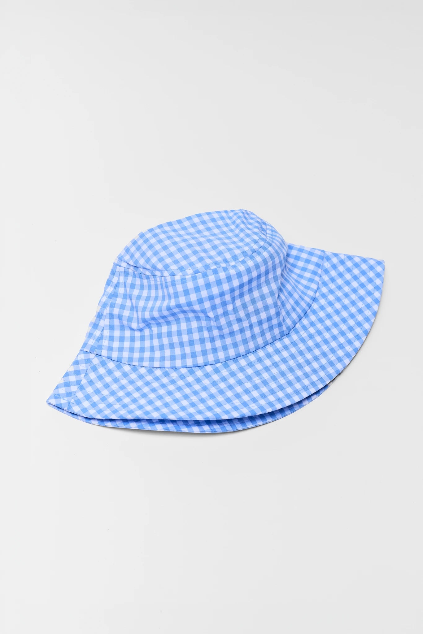 Blue and white checkered bucket hat on a light gray background