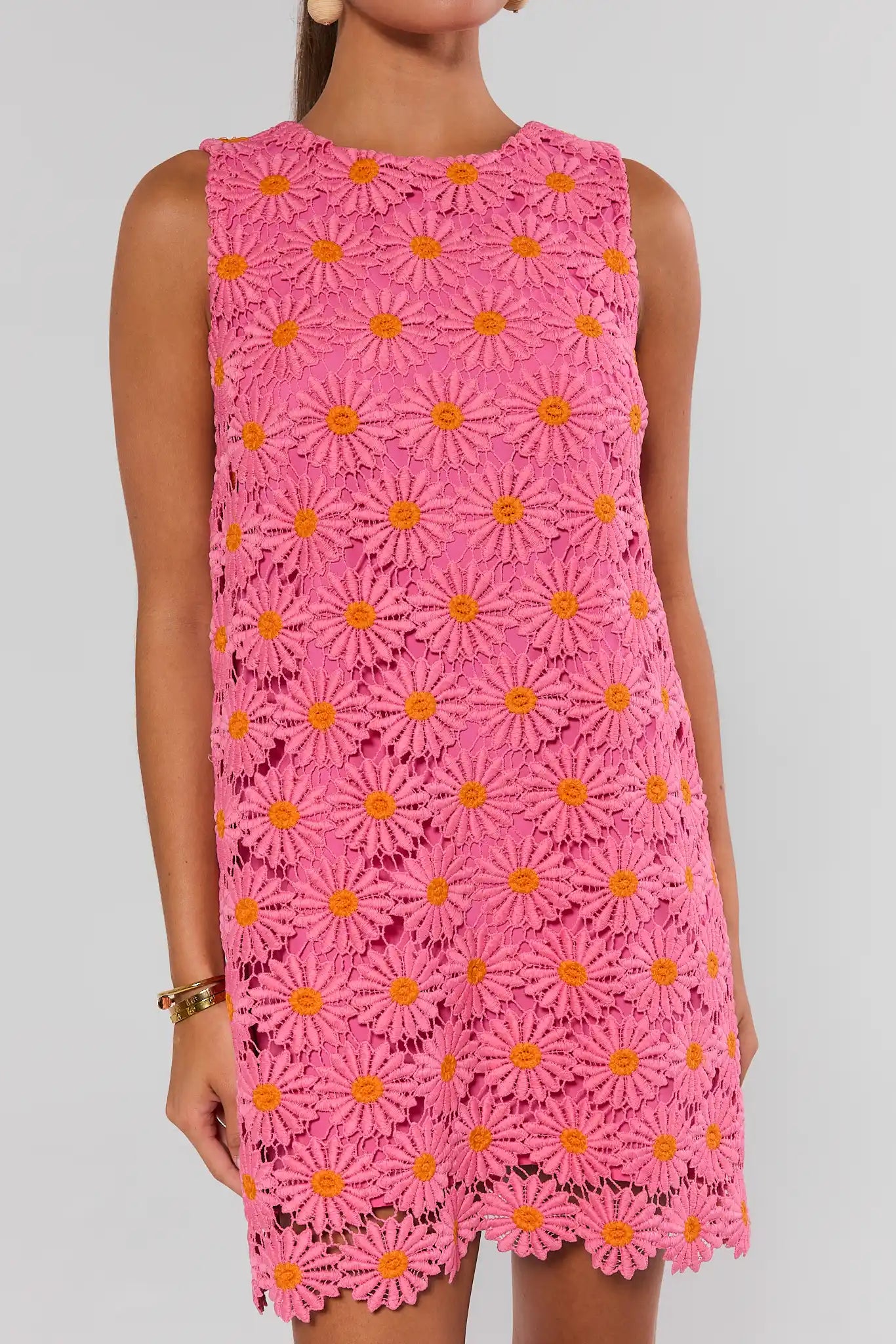 Pink dress with floral pattern on a plain background close up