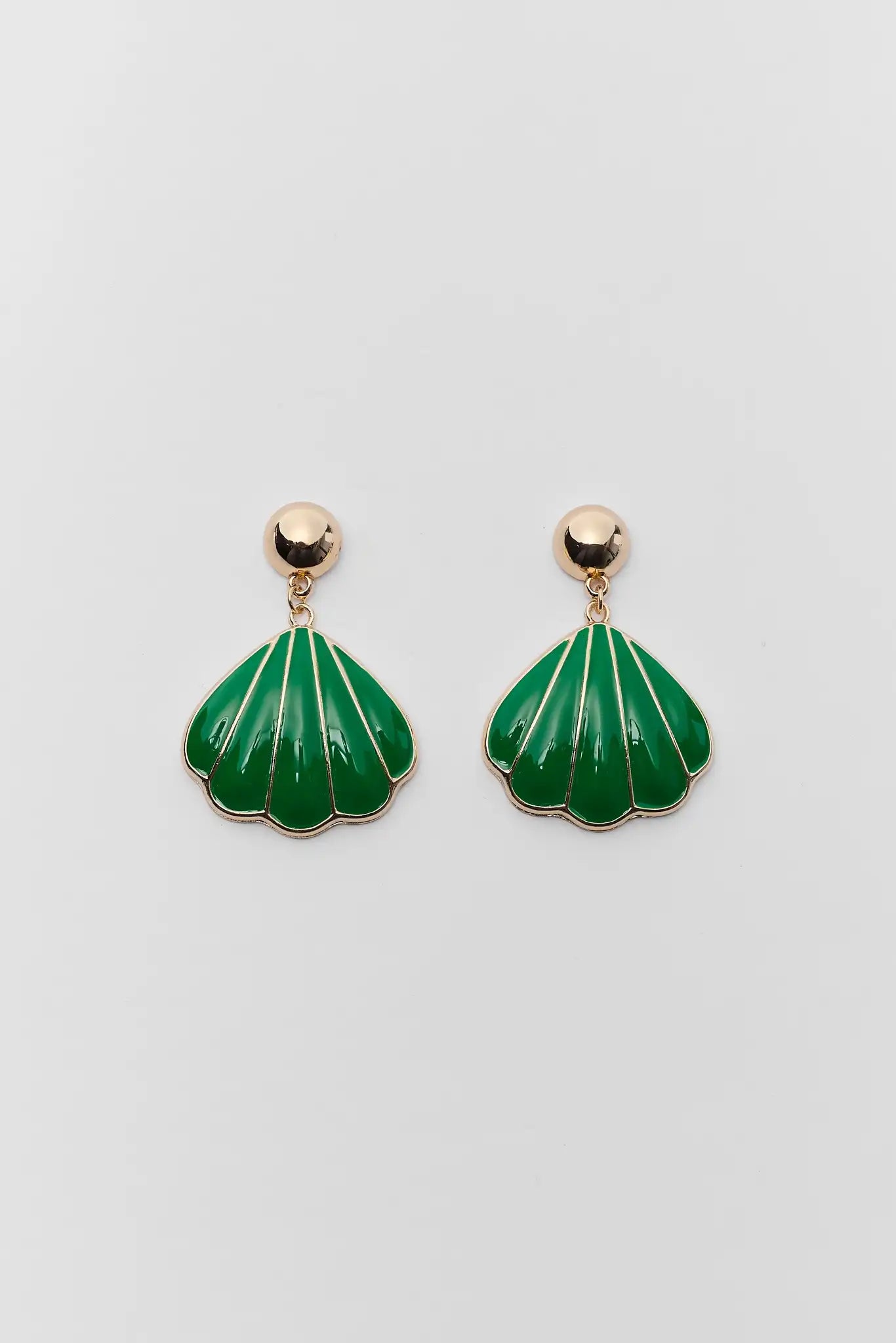 Green shell-shaped earrings on a light gray background