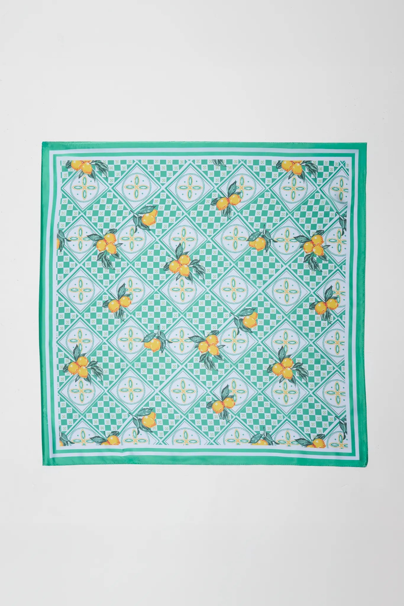 Green checkered scarf with yellow floral patterns on a white background