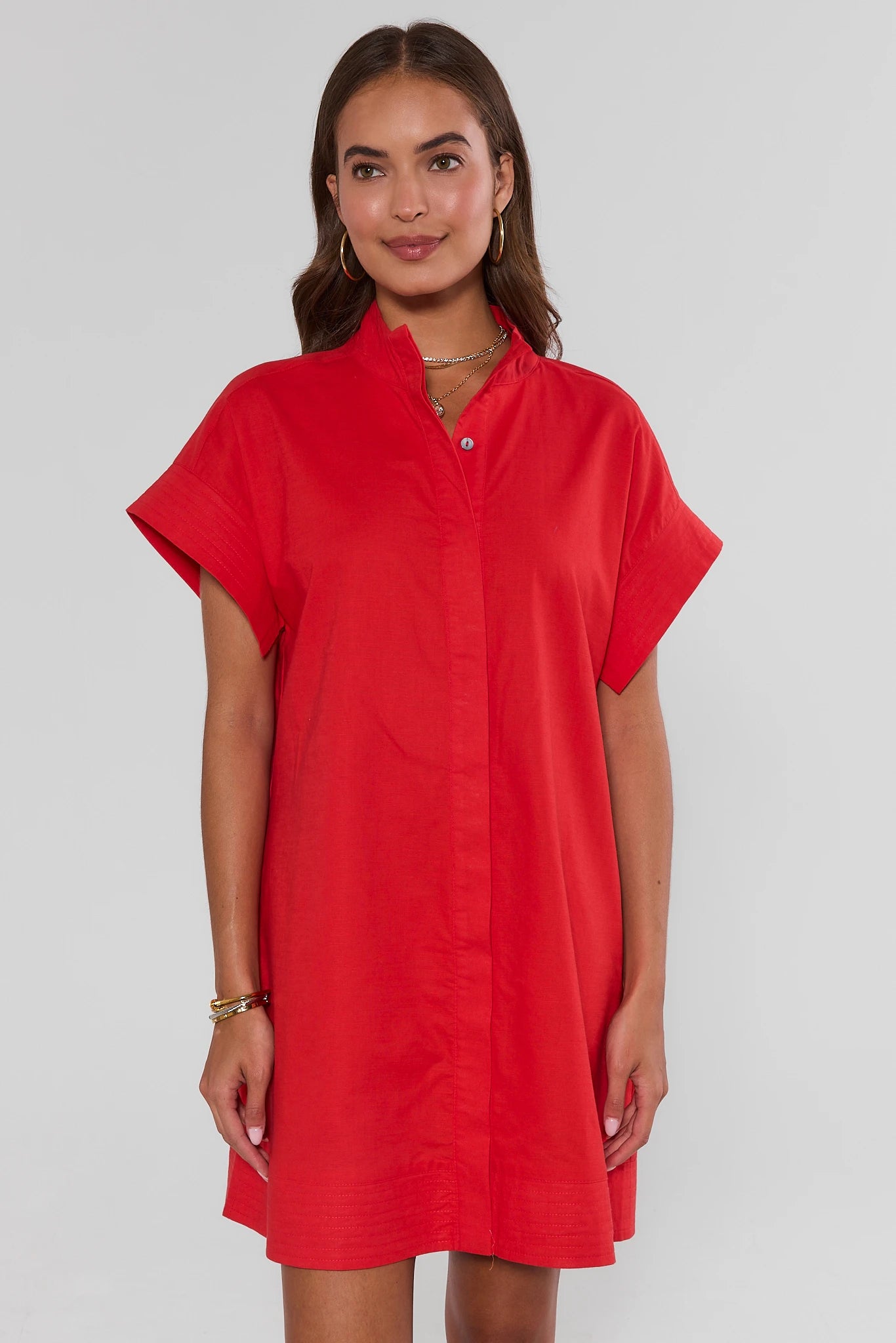 Woman wearing a red dress against a plain background