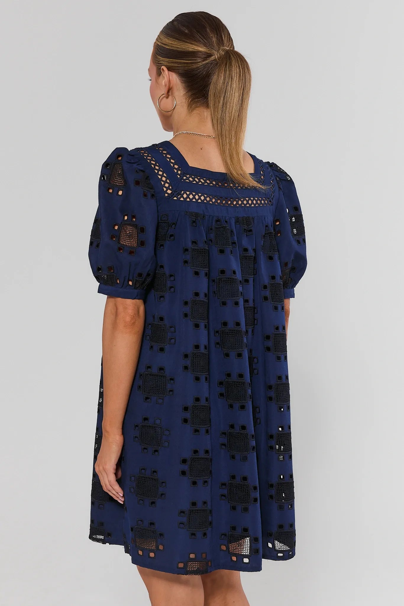 standing navy dress woman