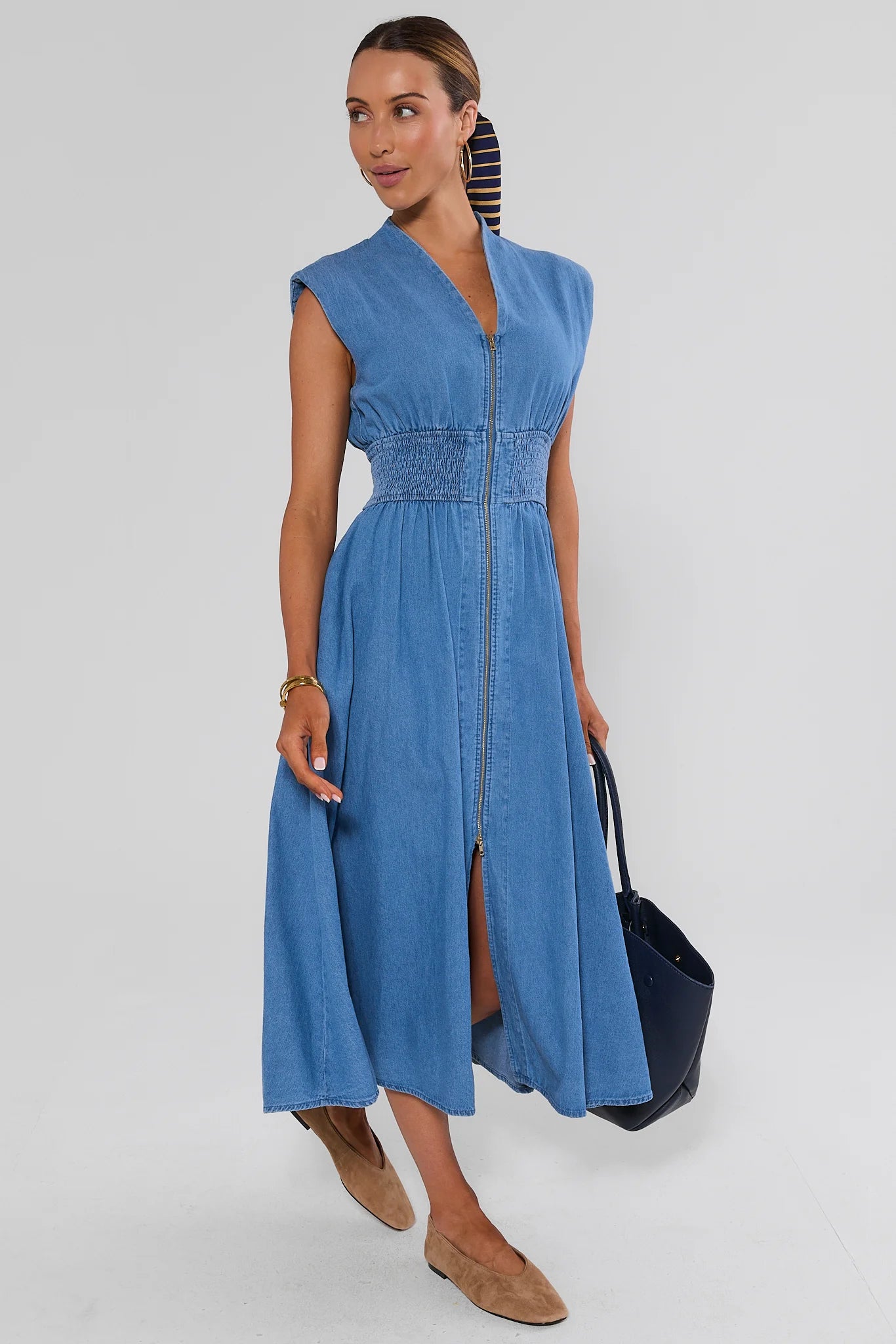 woman wearing collins medium wash dress on white background