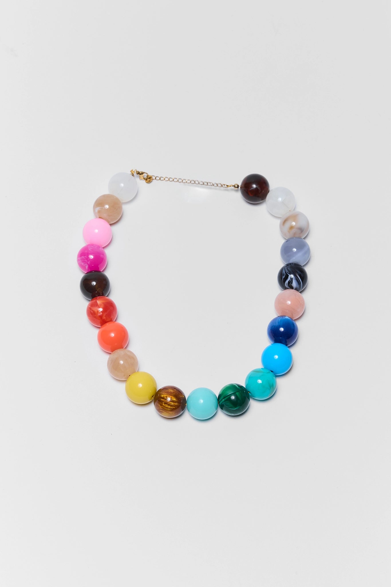multi colored rainbow beaded necklace on white background