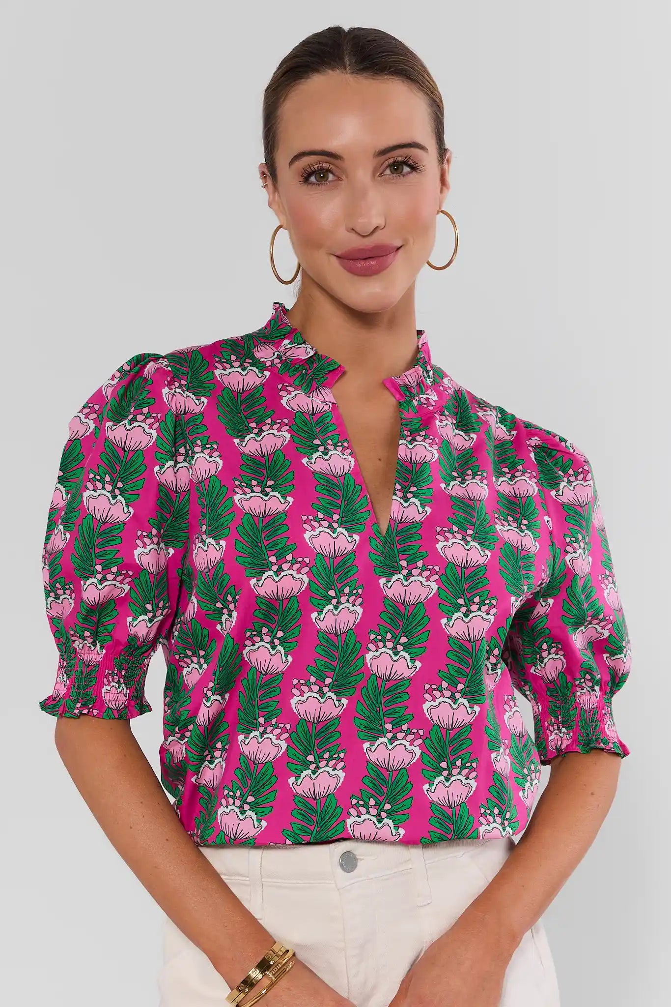 woman wearing amanda pink floral green top on white background