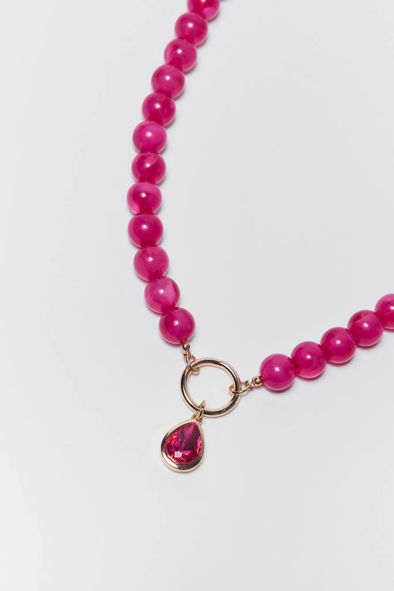 close up of Pink Stone Drop Necklace on a white background