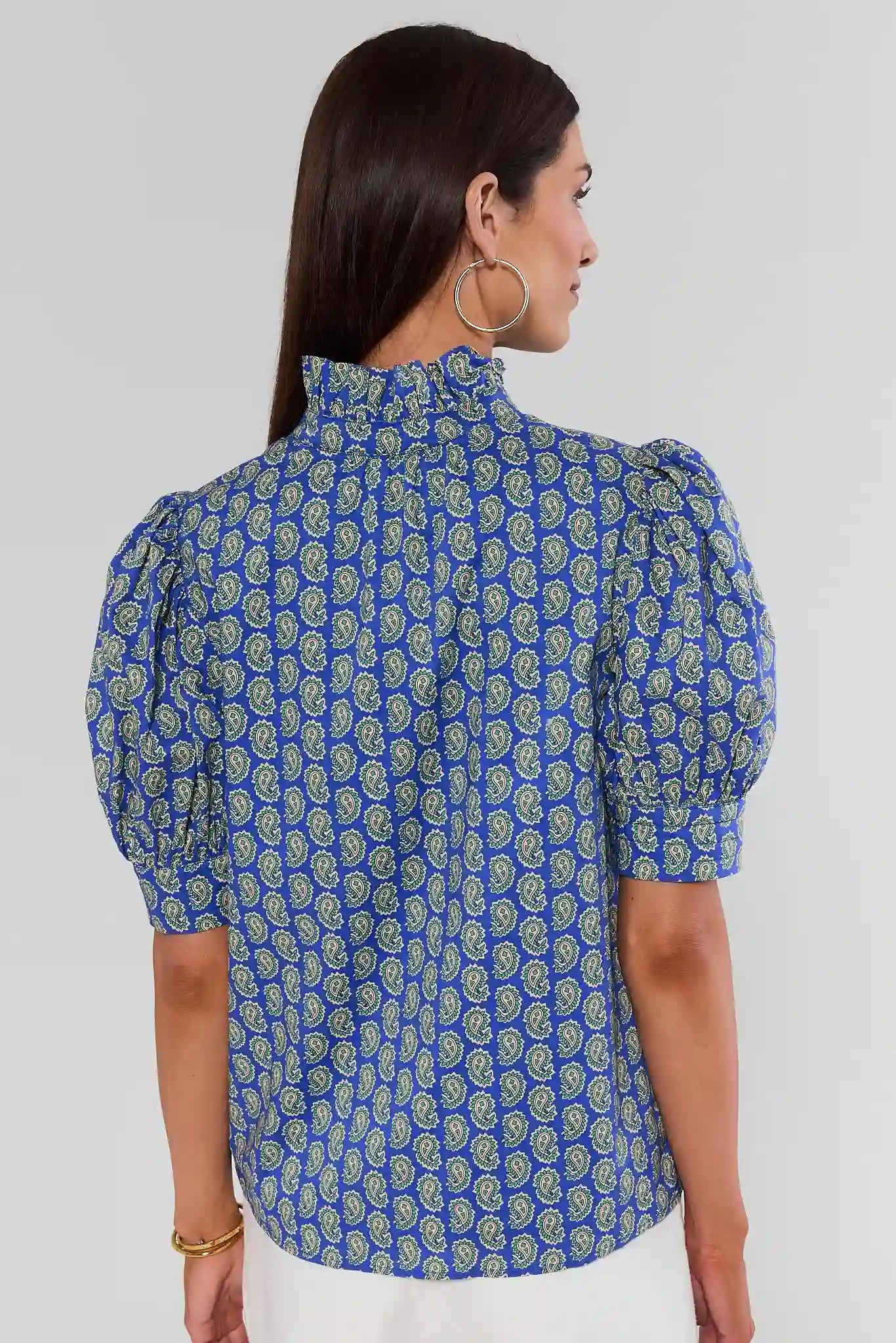 Woman turned wearing Gracie Navy Paisley Print Top on white background