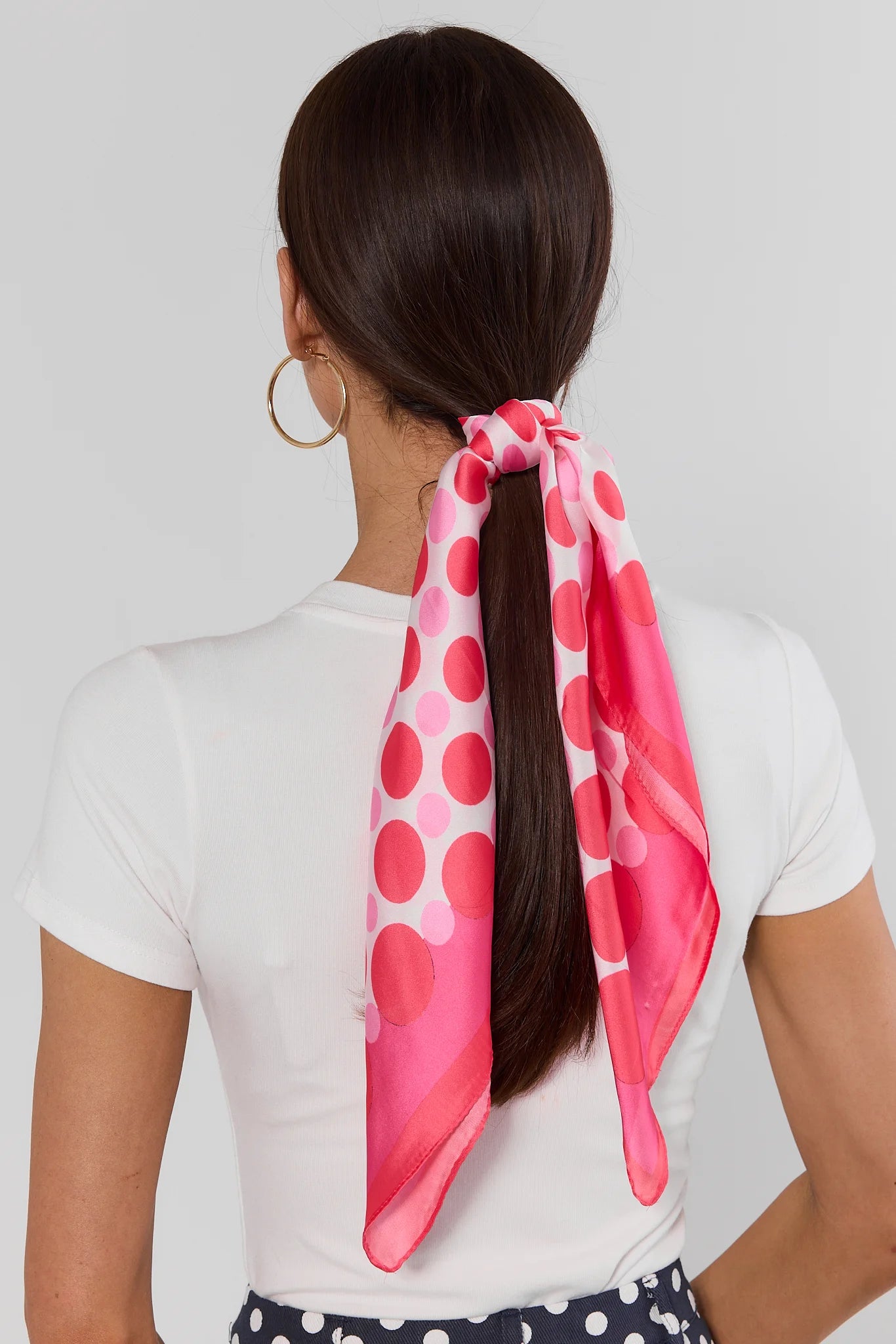 woman wearing Pink Multi Polka Dot Scarf tied in hair on white background