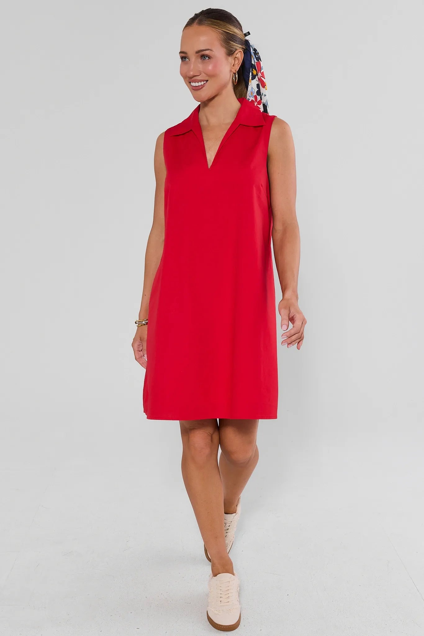 Woman walking wearing red ellen short dress on white background