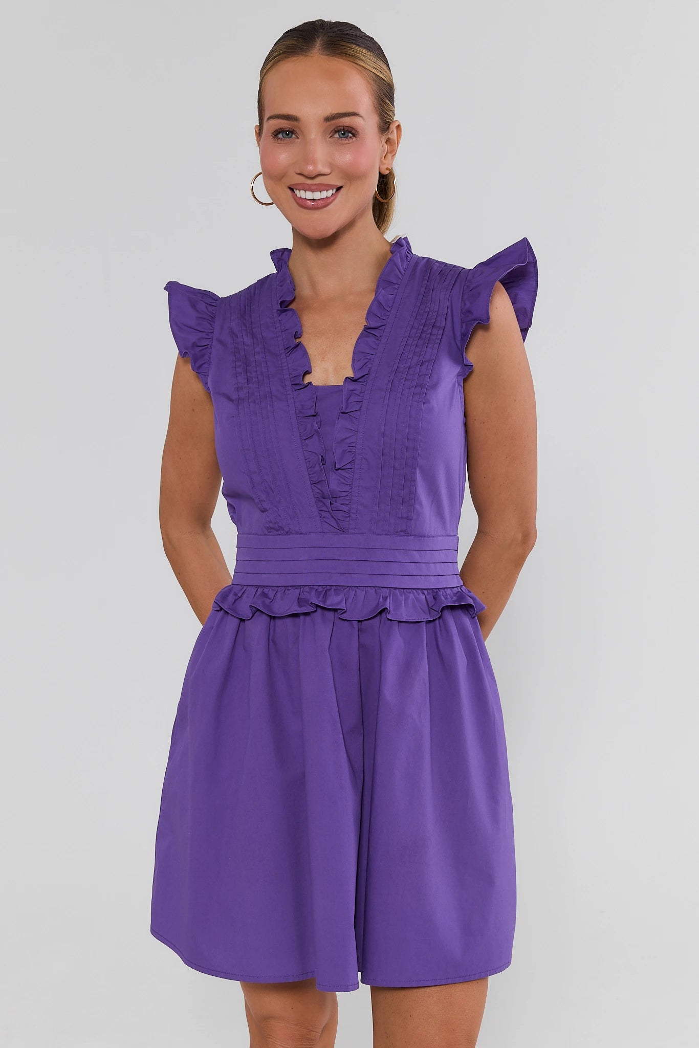 woman wearing Makayla Purple Flutter Sleeve Short Dress on a white background
