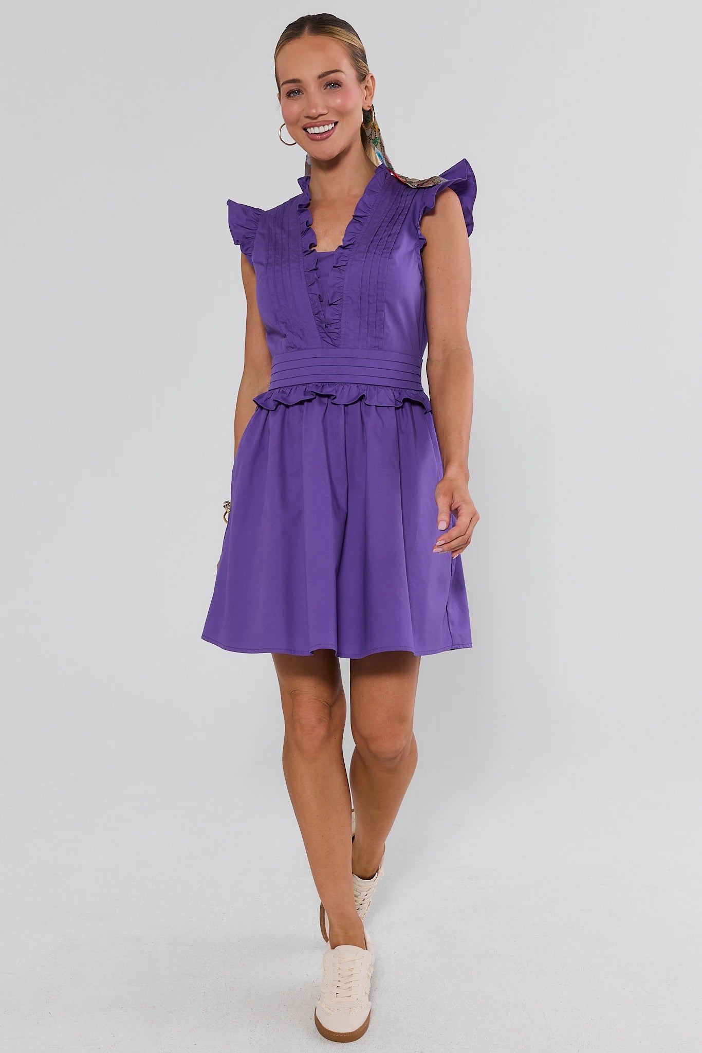 woman walking wearing Makayla Purple Flutter Sleeve Short Dress on a white background