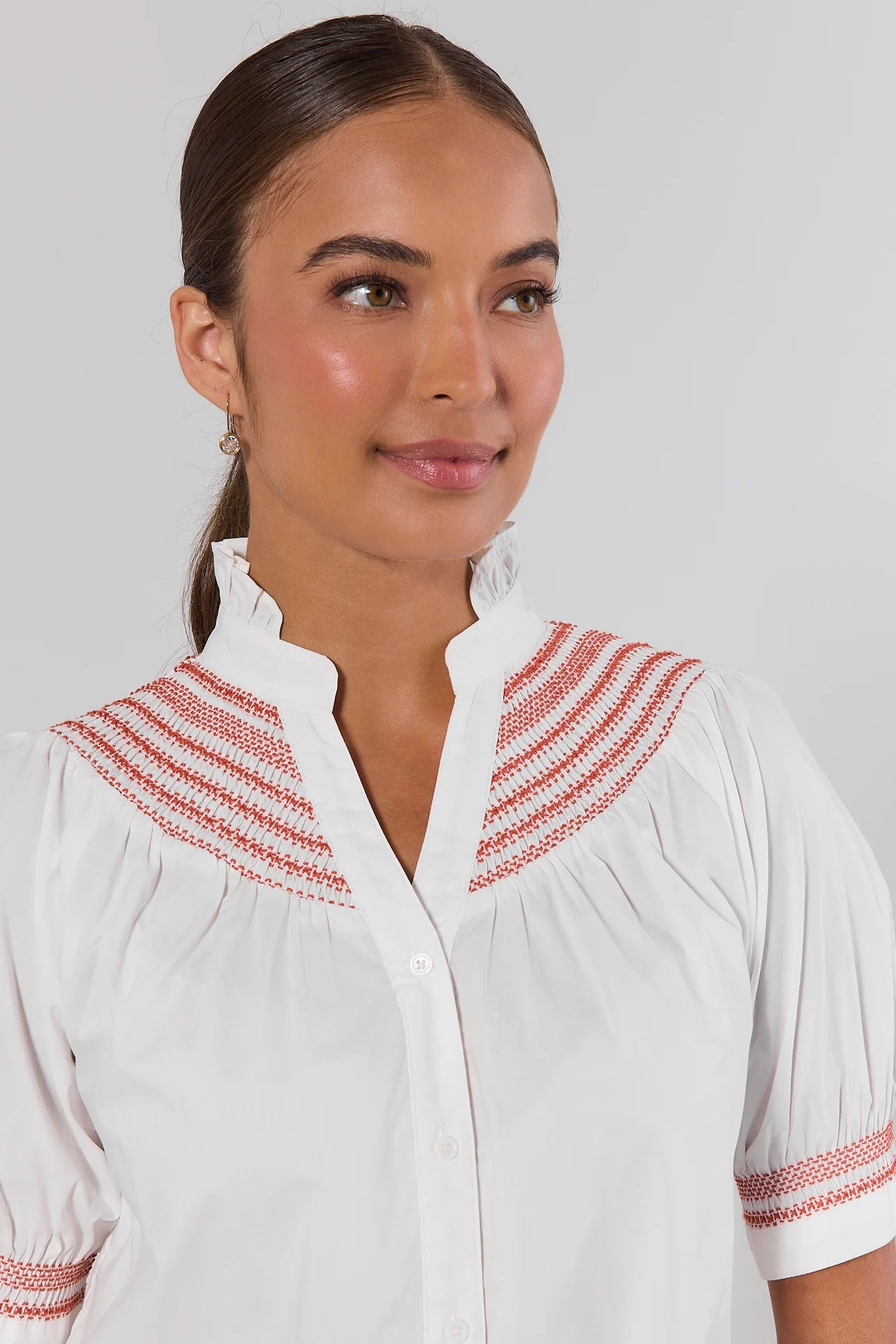 close up Woman wearing Yvonne White and Orange Embroidered Top on a white background