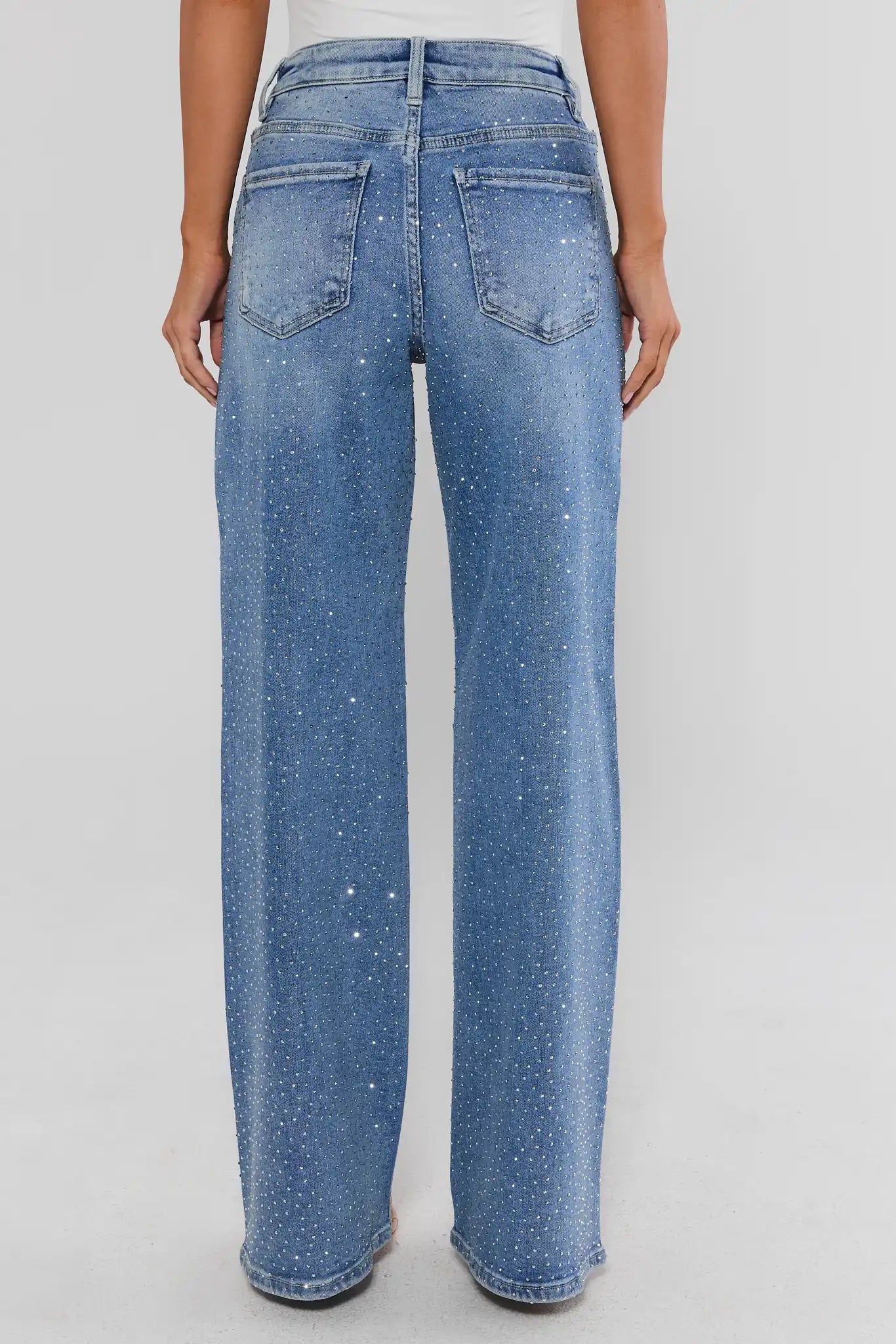 Woman standing wearing Carrie Rhinestone Wide Leg Jeans on a white background