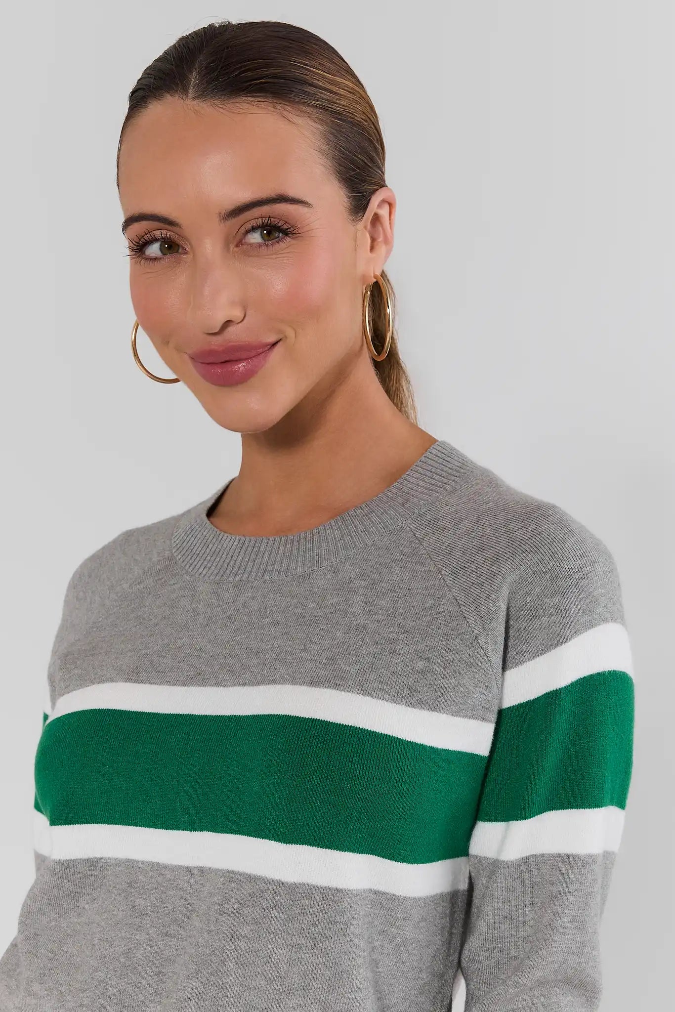 close up Woman wearing Dylan Green Stripe Sweater on a white background