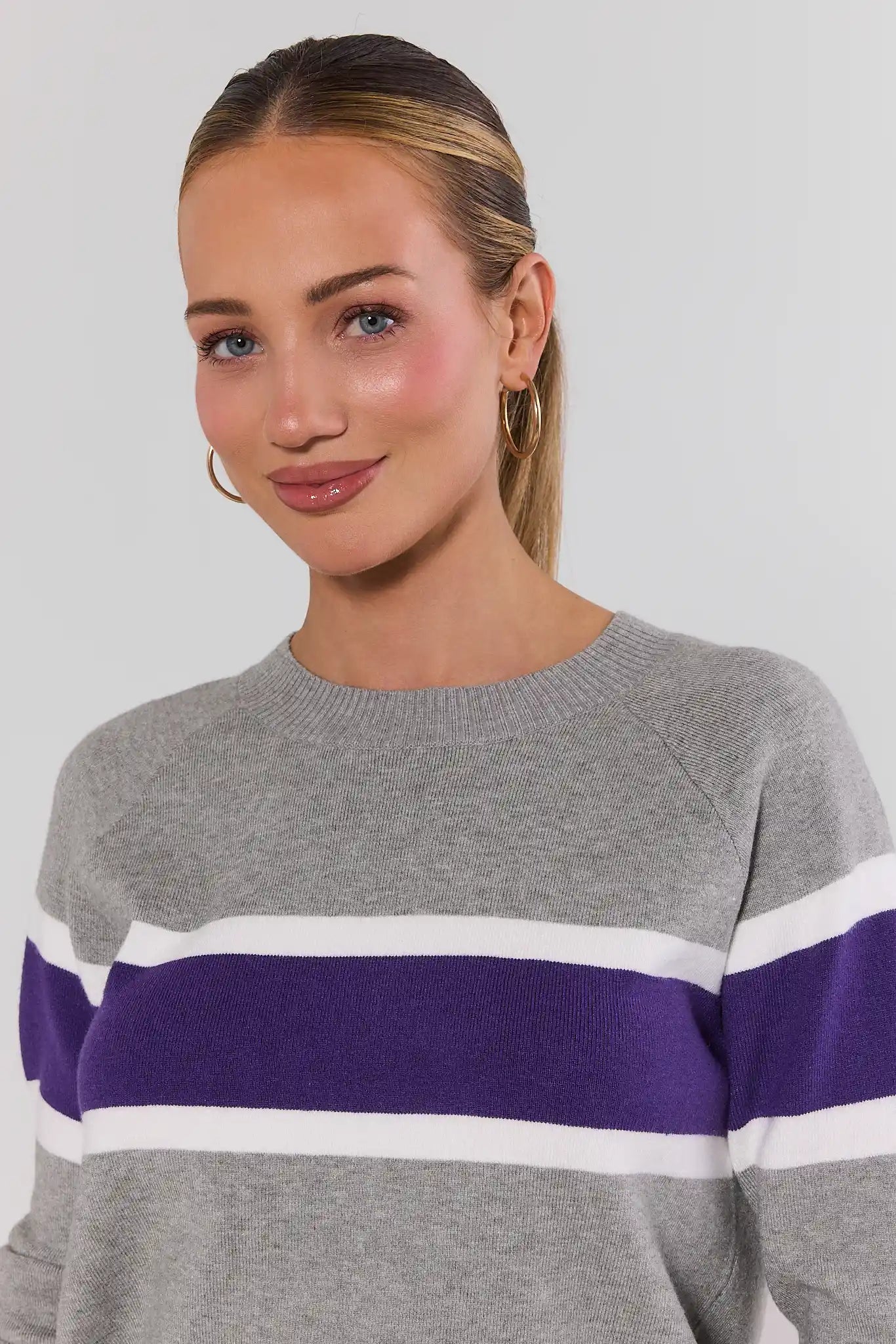close up Woman wearing Dylan Purple Stripe Sweater on a white background