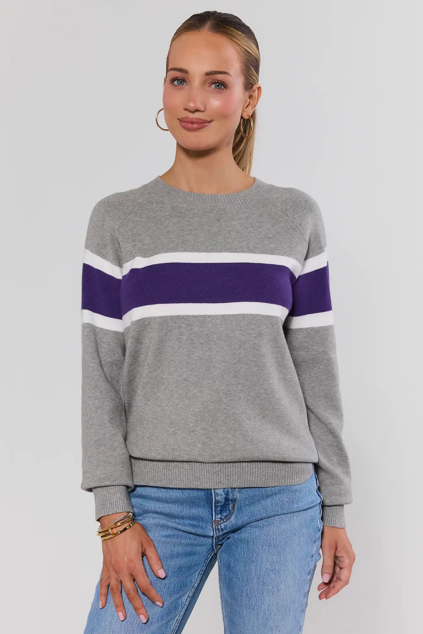 Woman wearing Dylan Purple Stripe Sweater on a white background