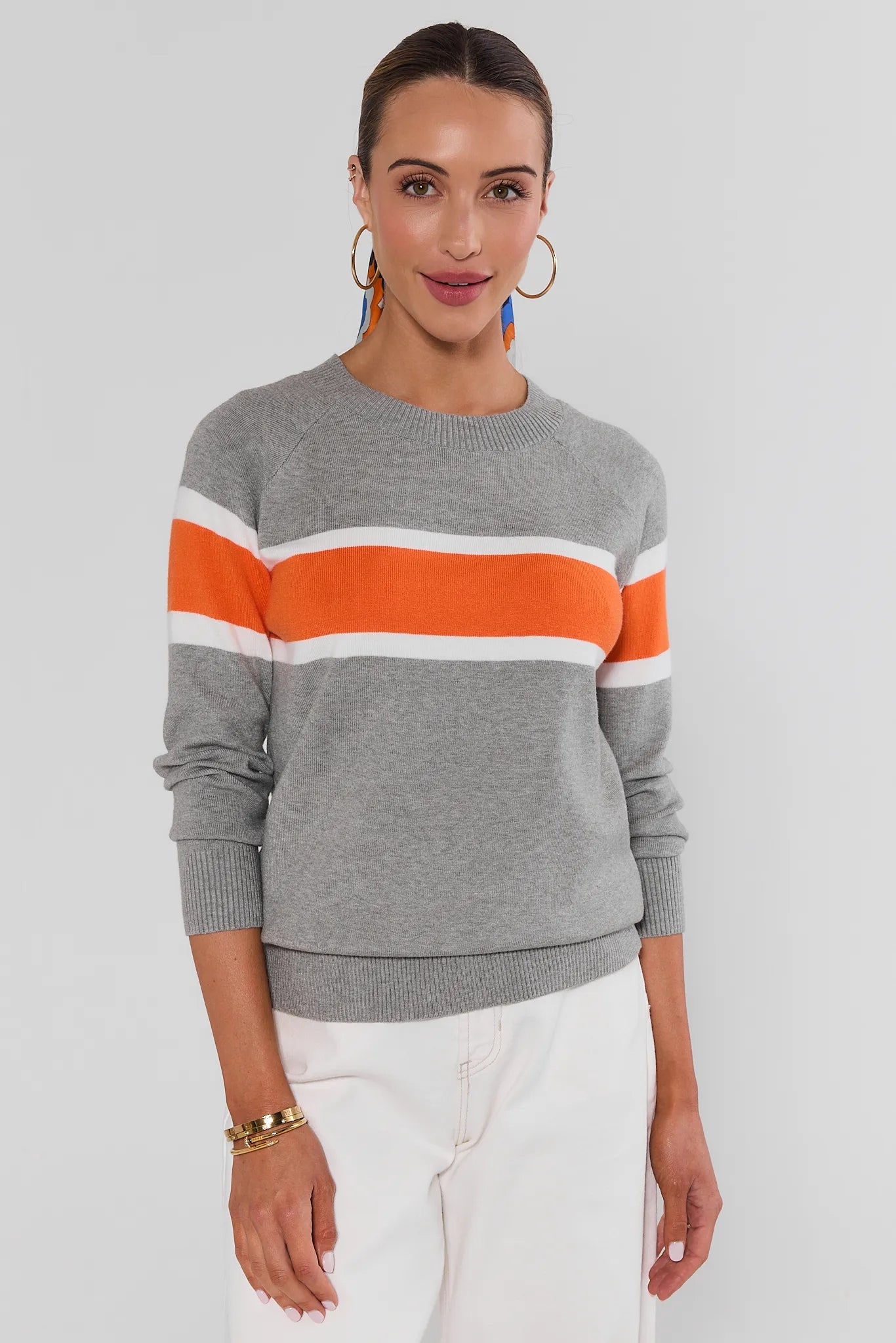 Woman wearing Dylan Orange Stripe Sweater on a white background