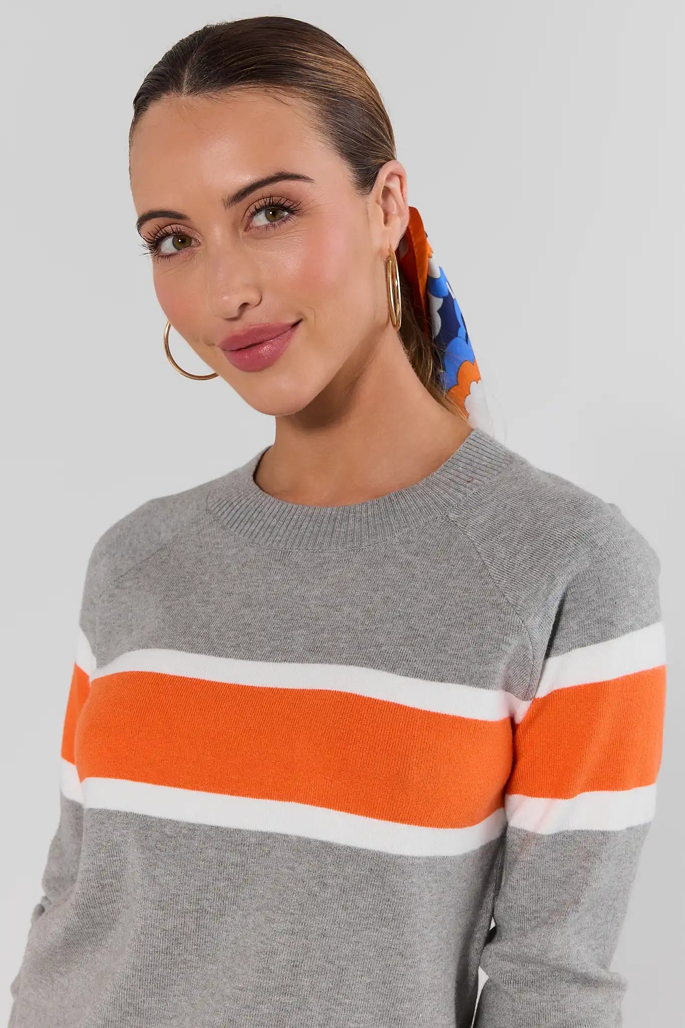 close up Woman wearing Dylan Orange Stripe Sweater on a white background