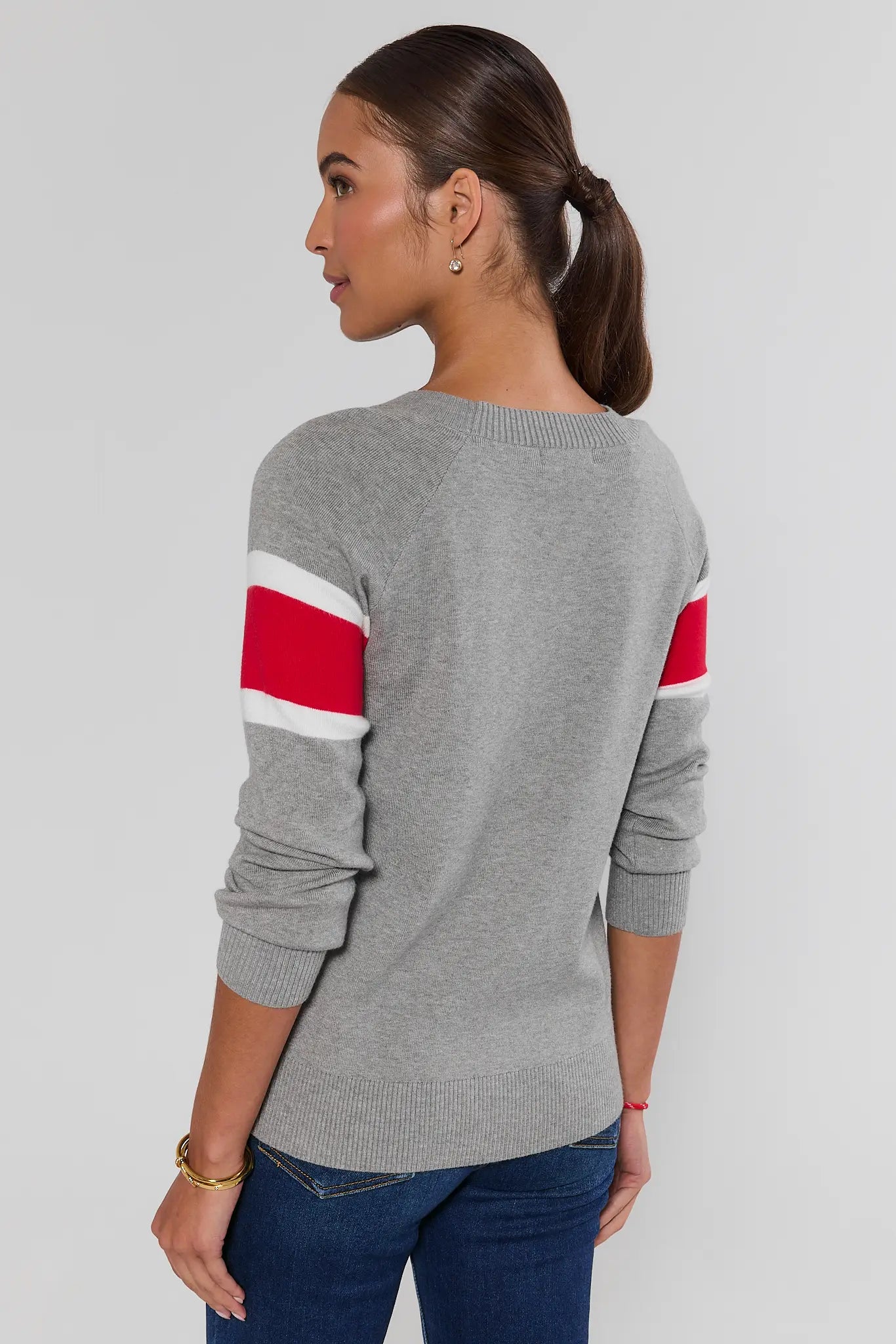 Woman wearing Dylan Red Stripe Sweater on a white background standing