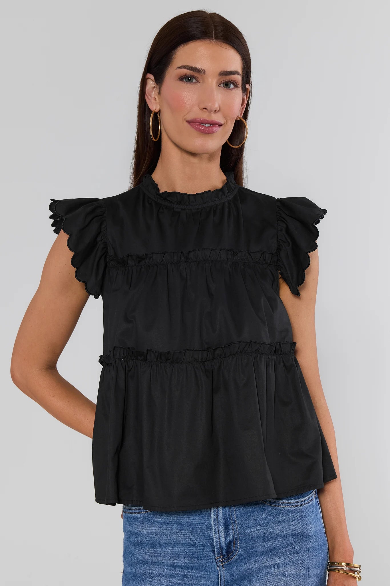 woman wearing Black Tiered Flutter Sleeve Top on a white background