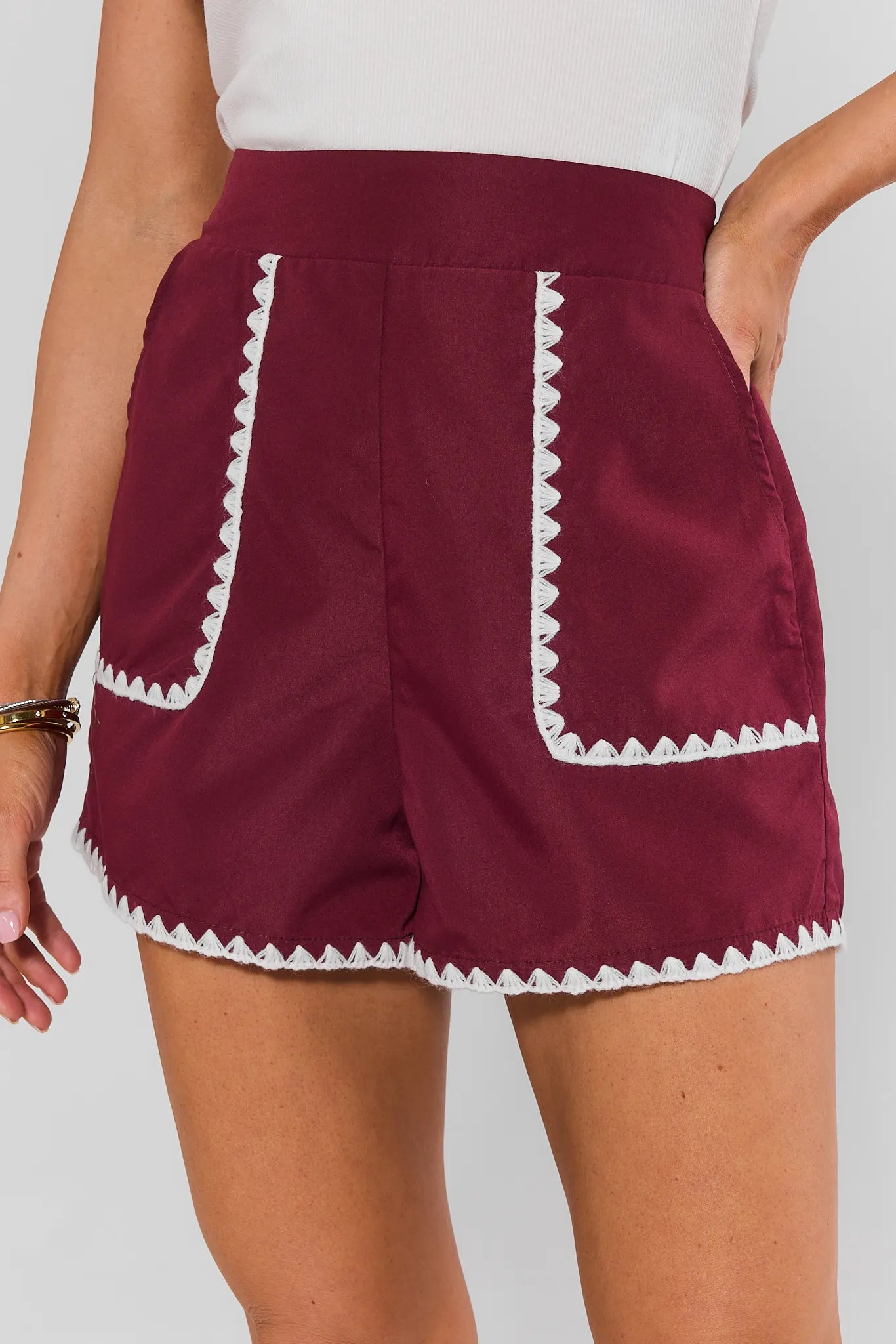 Woman wearing Maroon Embroidered Trim Shorts on a white background