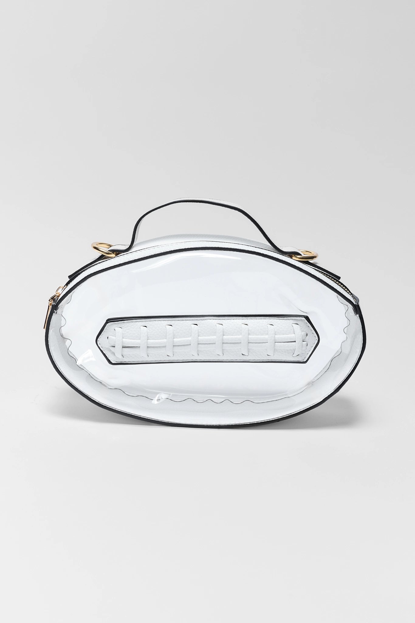 A white faux-leather handbag with a glossy finish, featuring a black top handle, black piping, and gold-tone hardware on a light gray background.