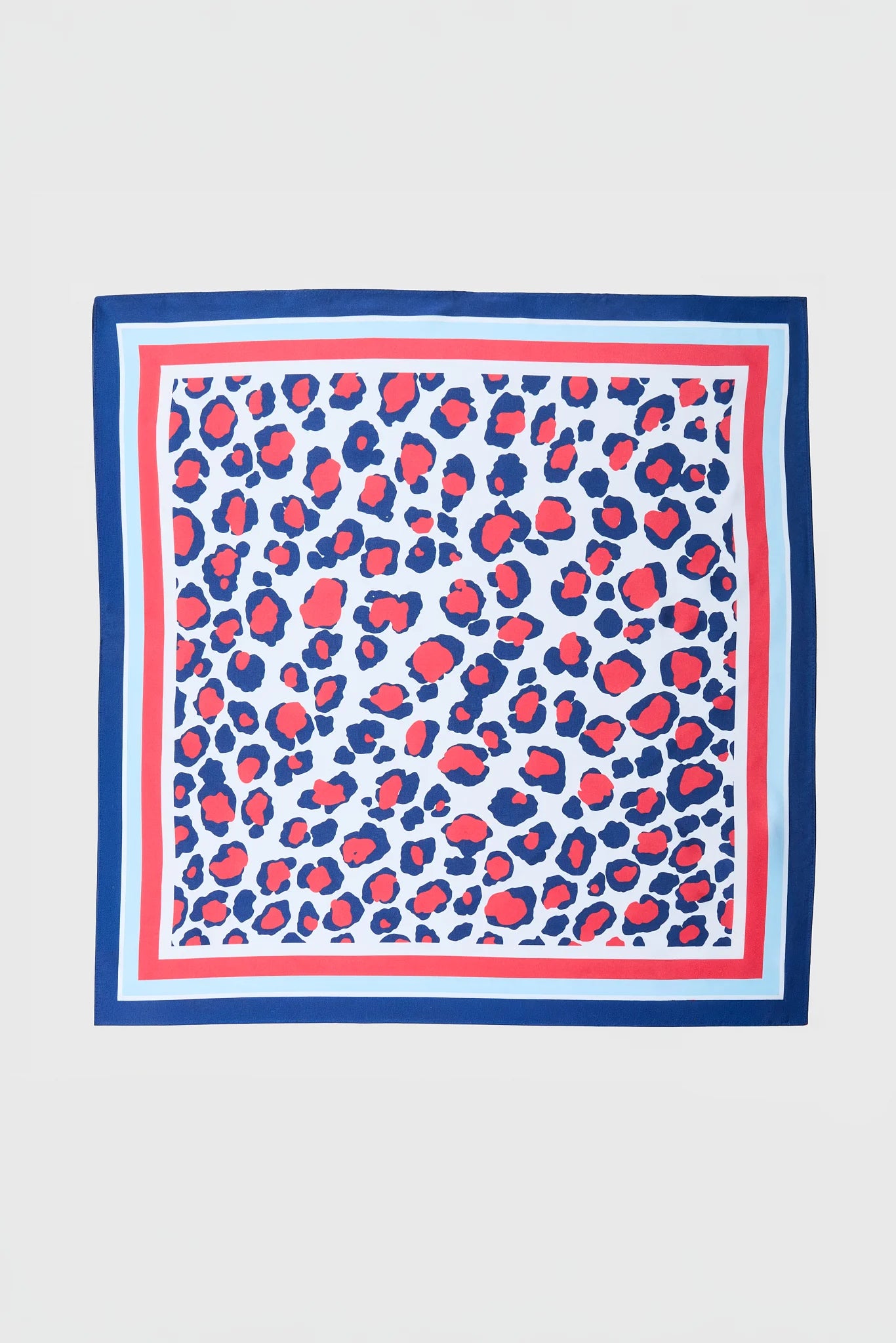 A square scarf with a blue and red leopard print pattern on a white background, framed by a striped border of navy, red, and light blue, shown flat against a light gray background.