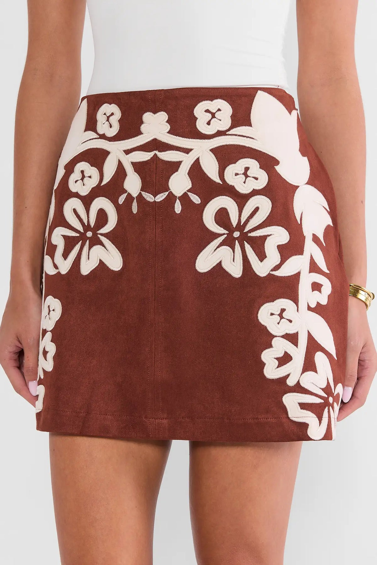 Brown Faux Suede Mini Skirt - Front Close-Up, Cream Floral Appliqué Detail | Avara
