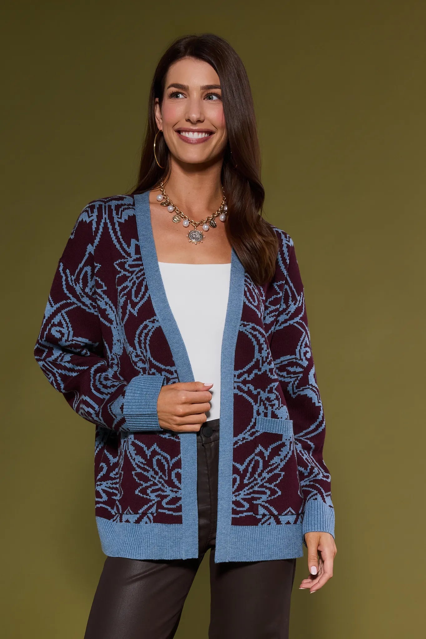 Woman wearing a patterned Liv Cardigan against a solid background