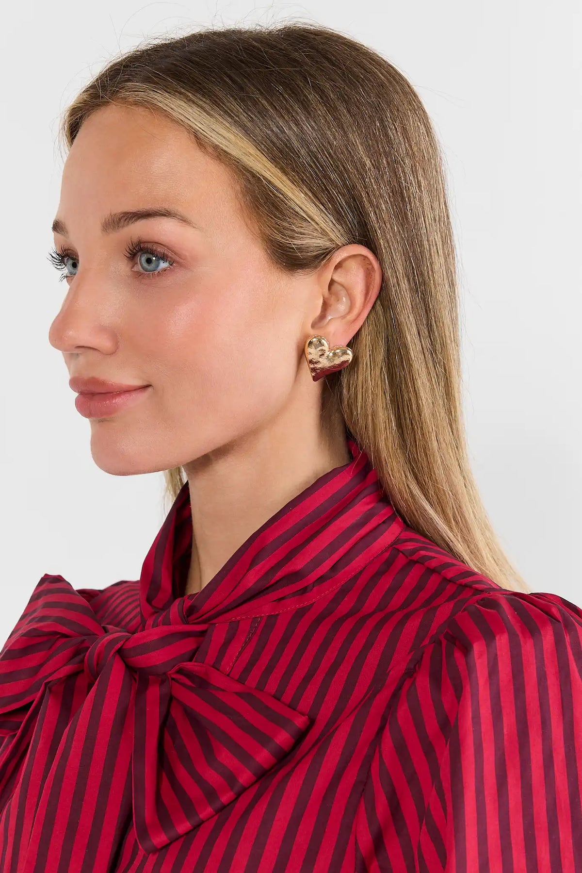 Gold Oversized Heart Stud Earrings - On Model with Red Striped Top | Avara