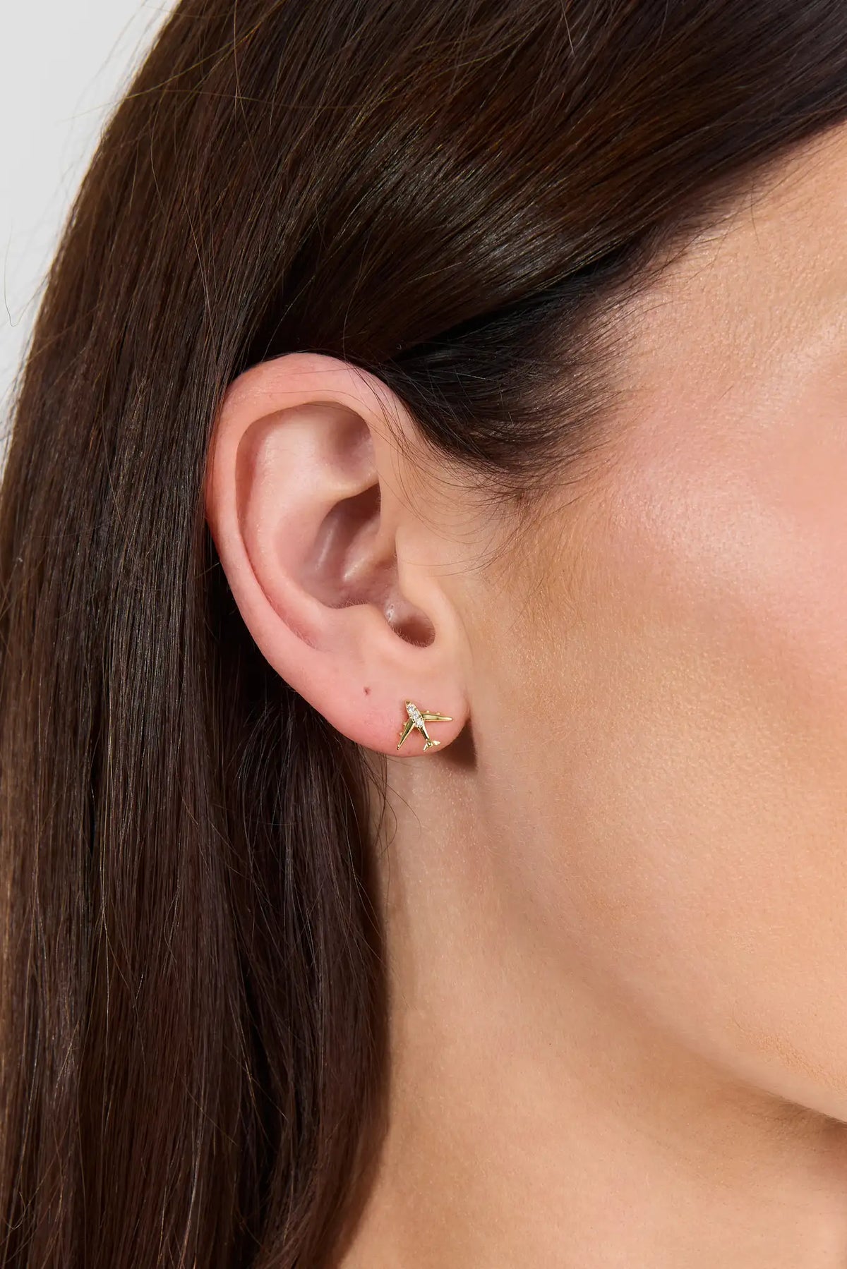 Gold Airplane Stud Earring with Rhinestone Detail - On Model Ear Close-Up | Avara