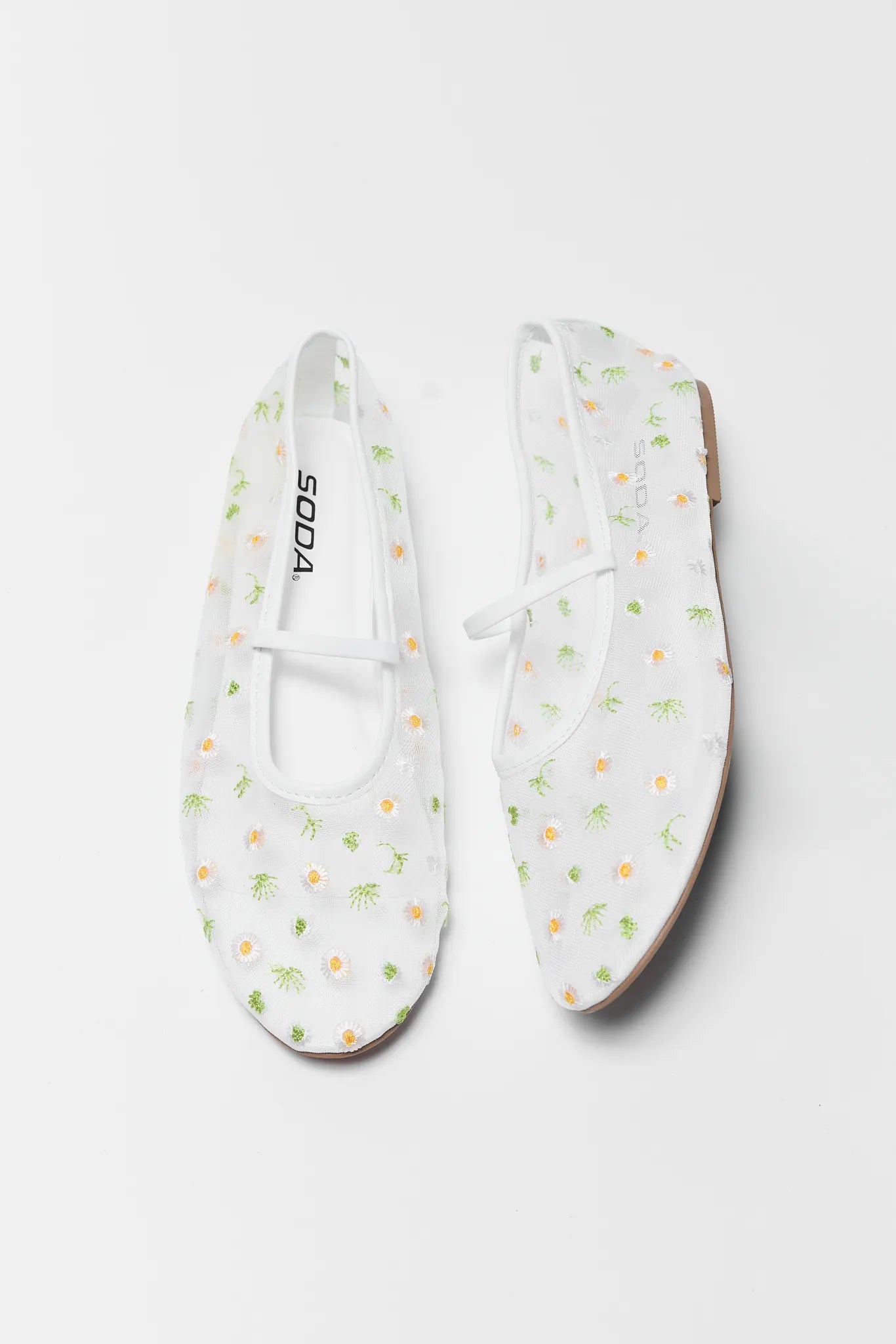 White floral-patterned shoes on a white background