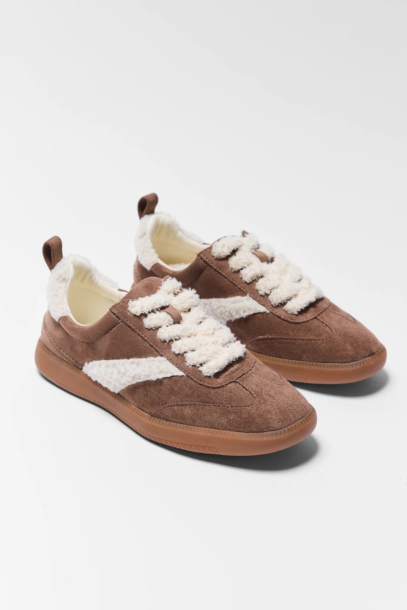 Brown sneakers with white laces and fur lining on a light gray background Winona Brown Sherpa Sneakers