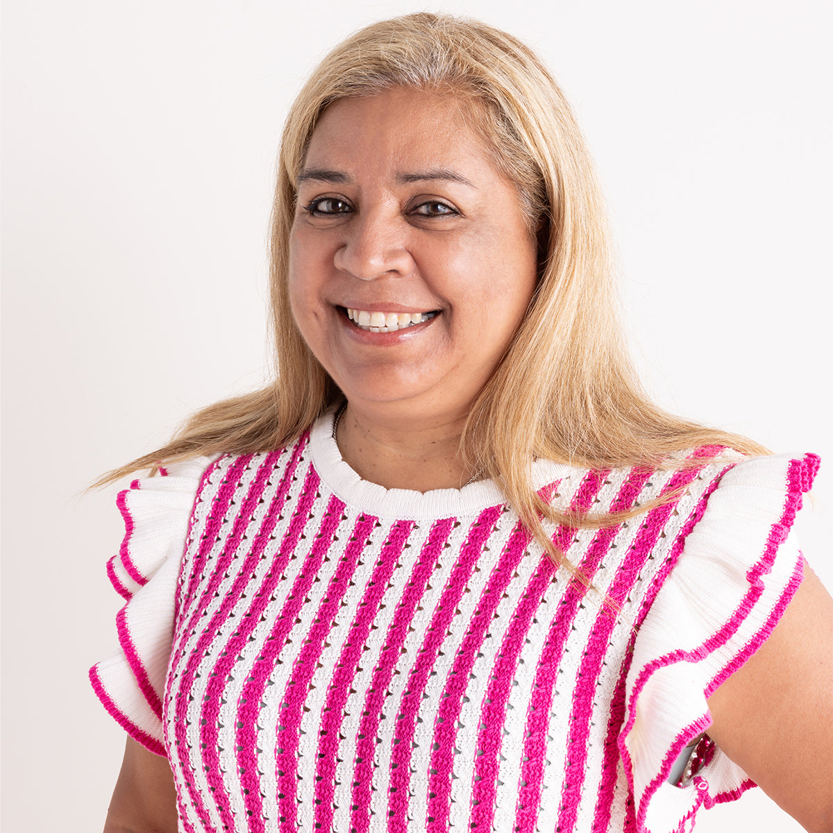 women wearing pink and white striped top with neutral backgroun