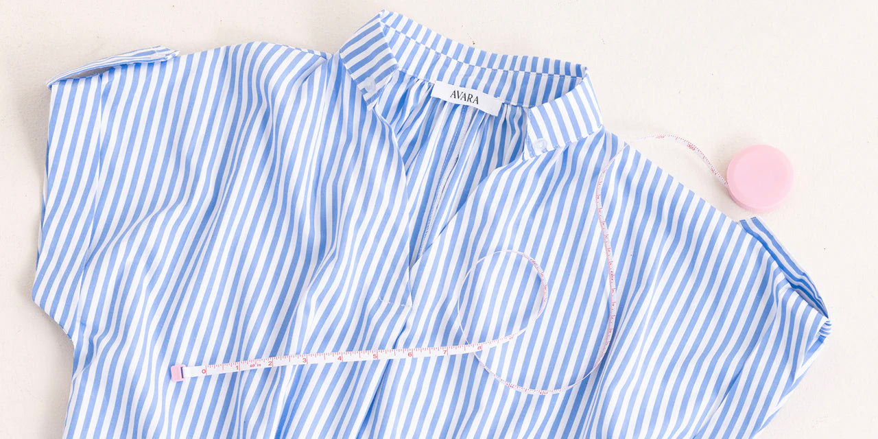 Blue and white striped shirt with a visible brand label on a light background