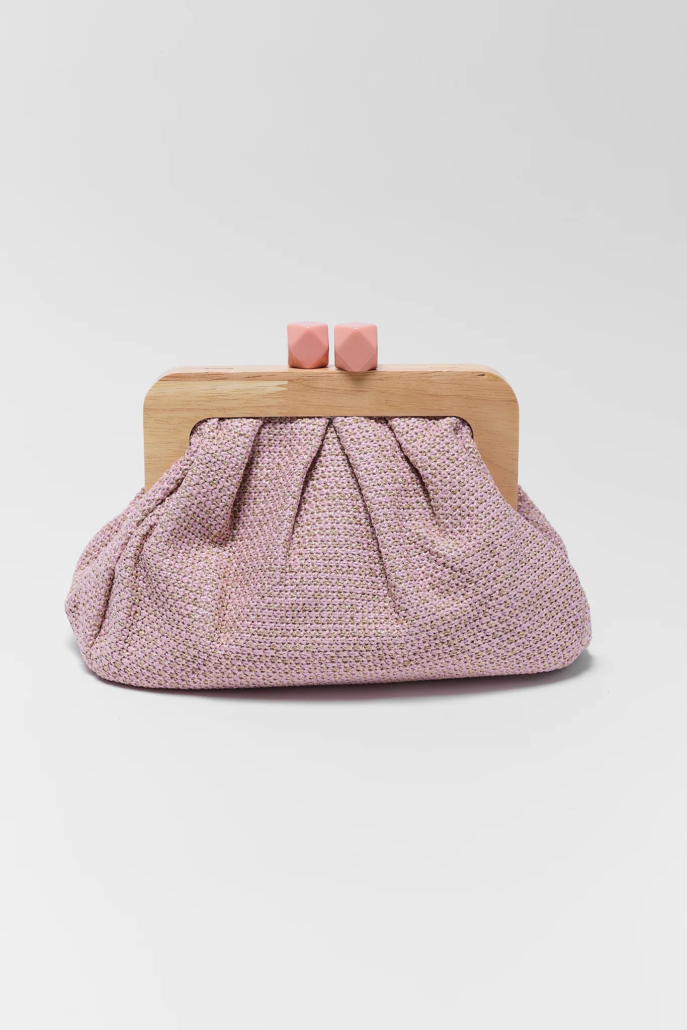 Pink textured clutch bag with wooden frame on a white background