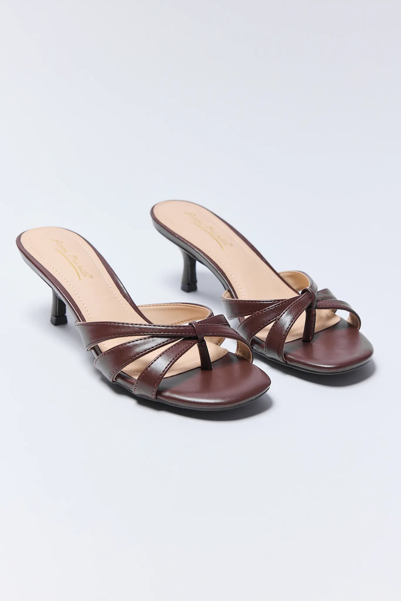 Pair of brown high-heeled Addison Heels
 on a light gray background