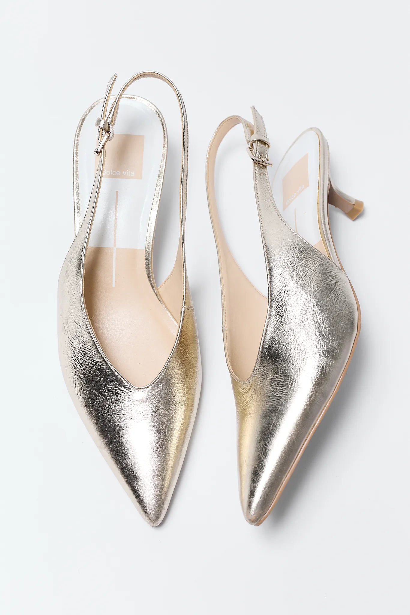 Pair of Alenna Gold Pointed Toe Heels on a white background