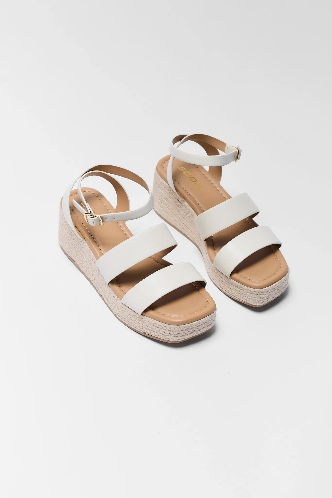 two Bella White Braided Wedges on white background