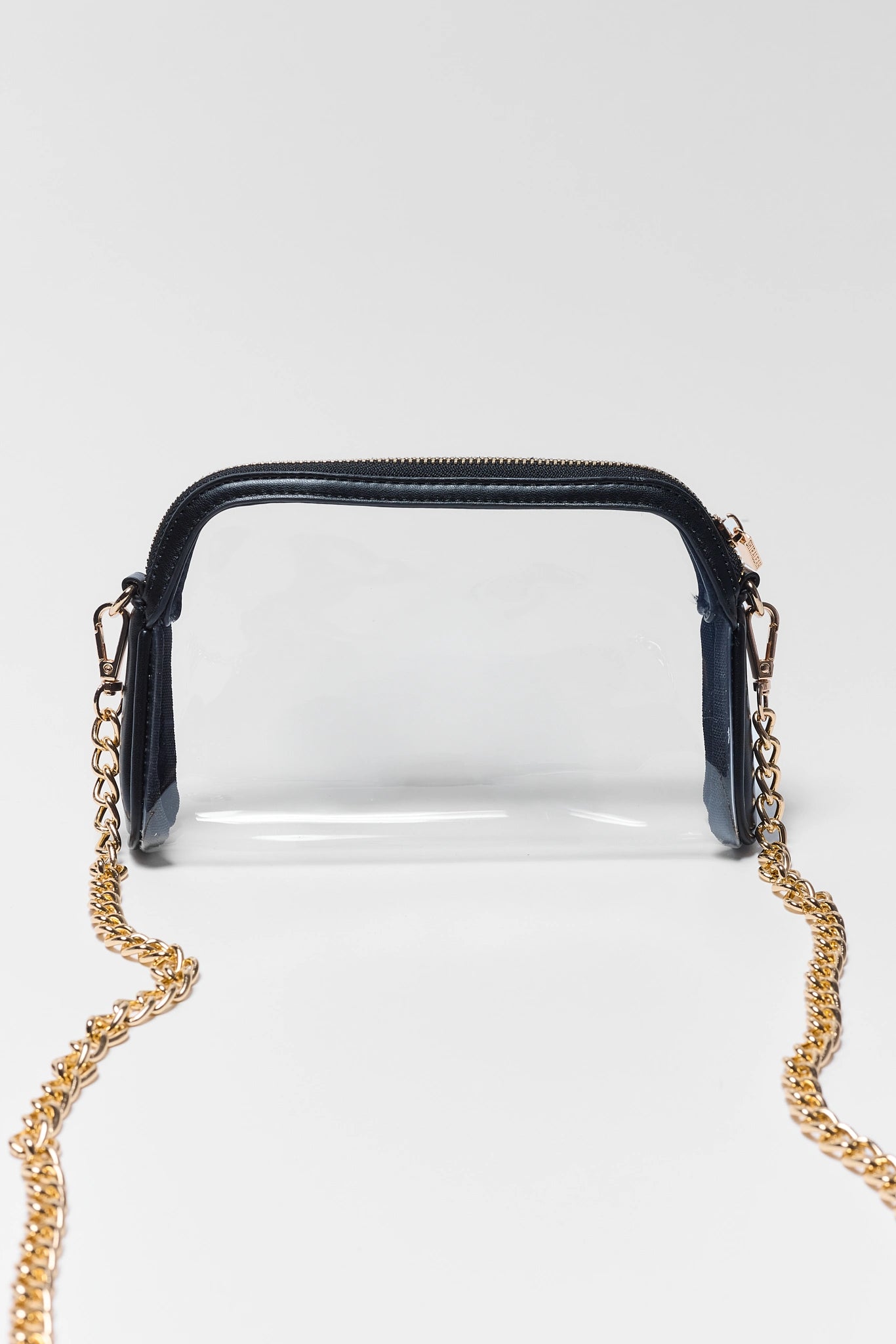 A clear plastic cosmetic pouch with a navy blue top trim and a gold-tone chain strap, shown against a light gray background.