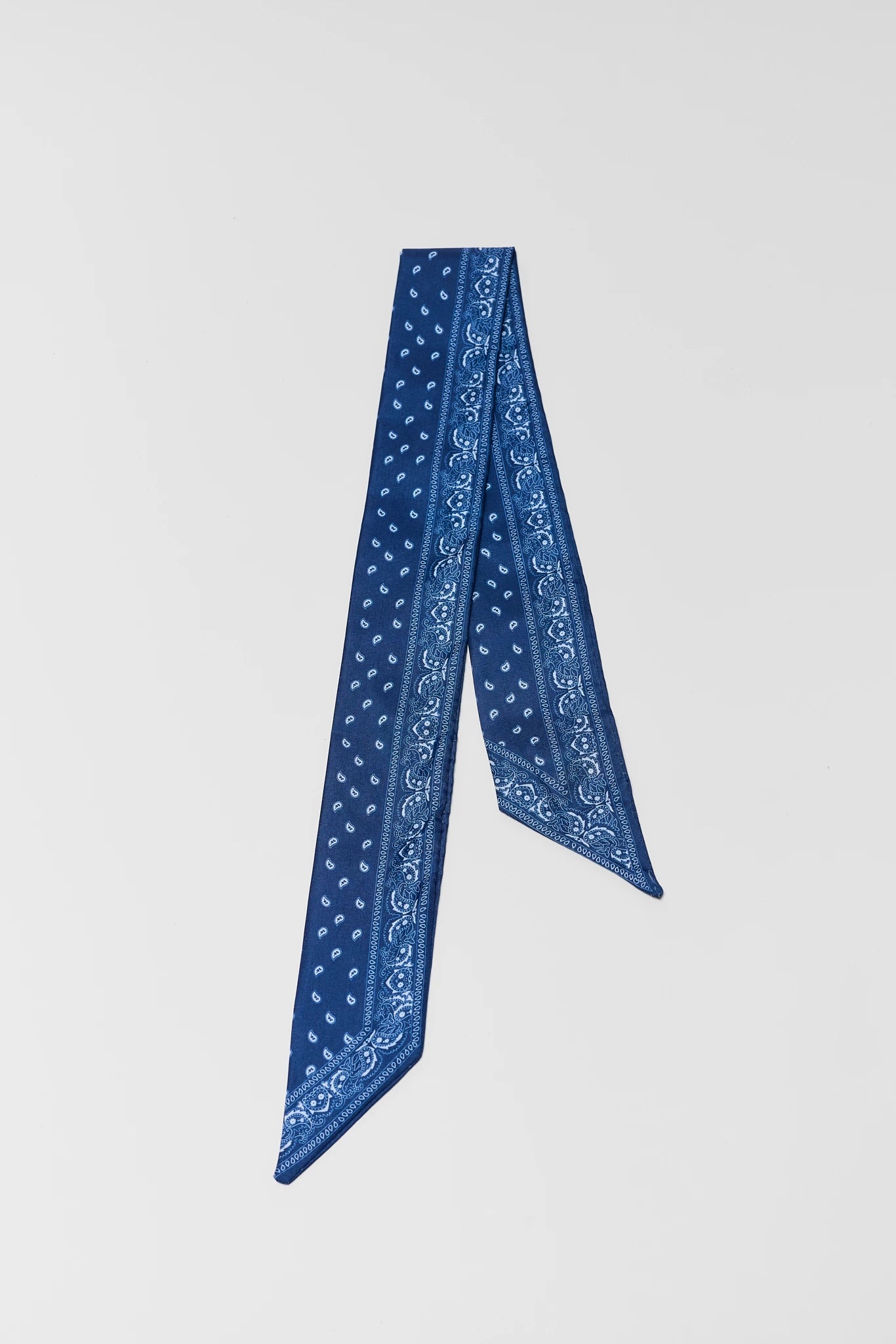 Blue patterned scarf on a light gray background